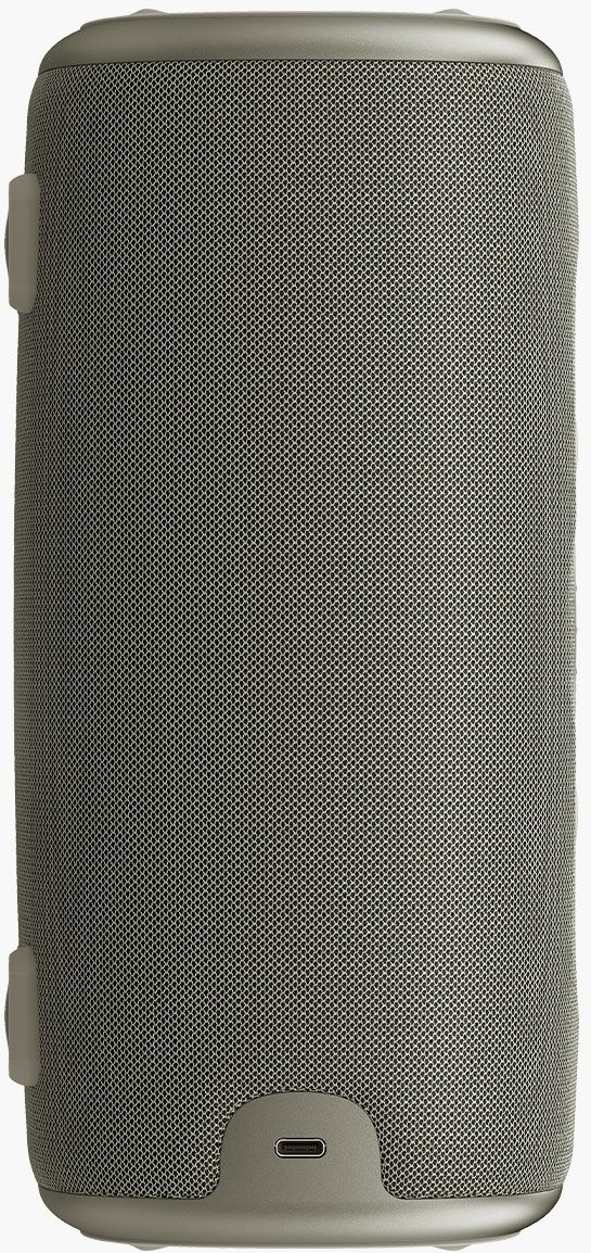 Un haut-parleur cylindrique avec une surface en maille. Il est de couleur gris clair et possède un port en bas. Deux boutons blancs sur le côté.