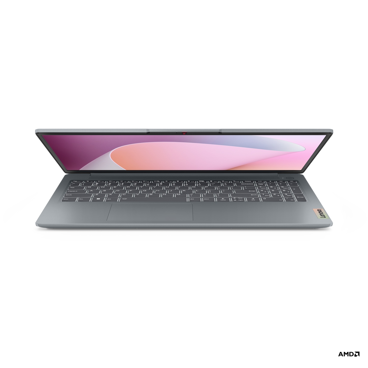 Un ordinateur portable Lenovo gris est ouvert. L'écran affiche un design rose et blanc. Clavier visible. Logo AMD en bas à droite.