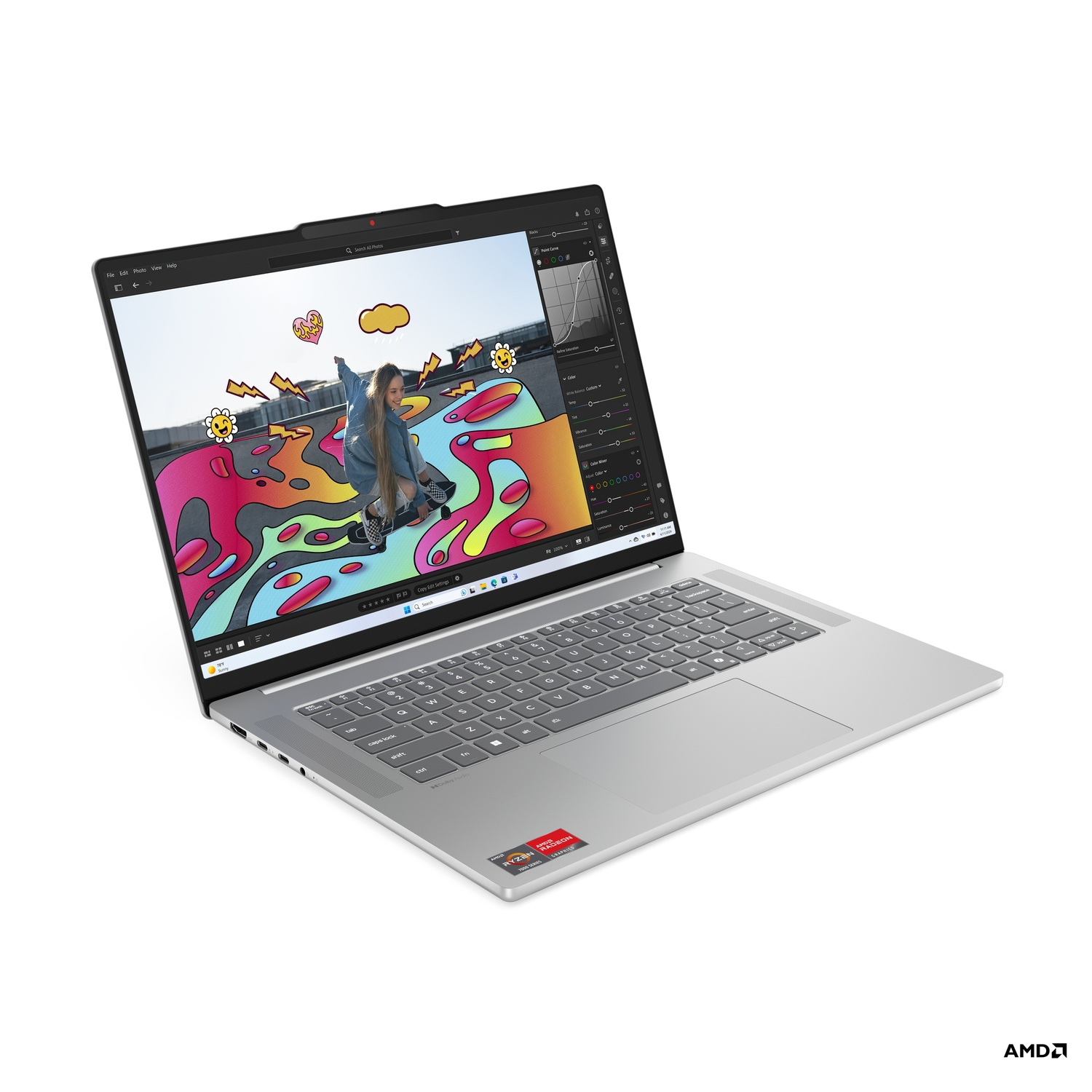 Silver laptop displaying photo editing software, showing a person skateboarding. AMD sticker in the bottom right corner of the laptop.