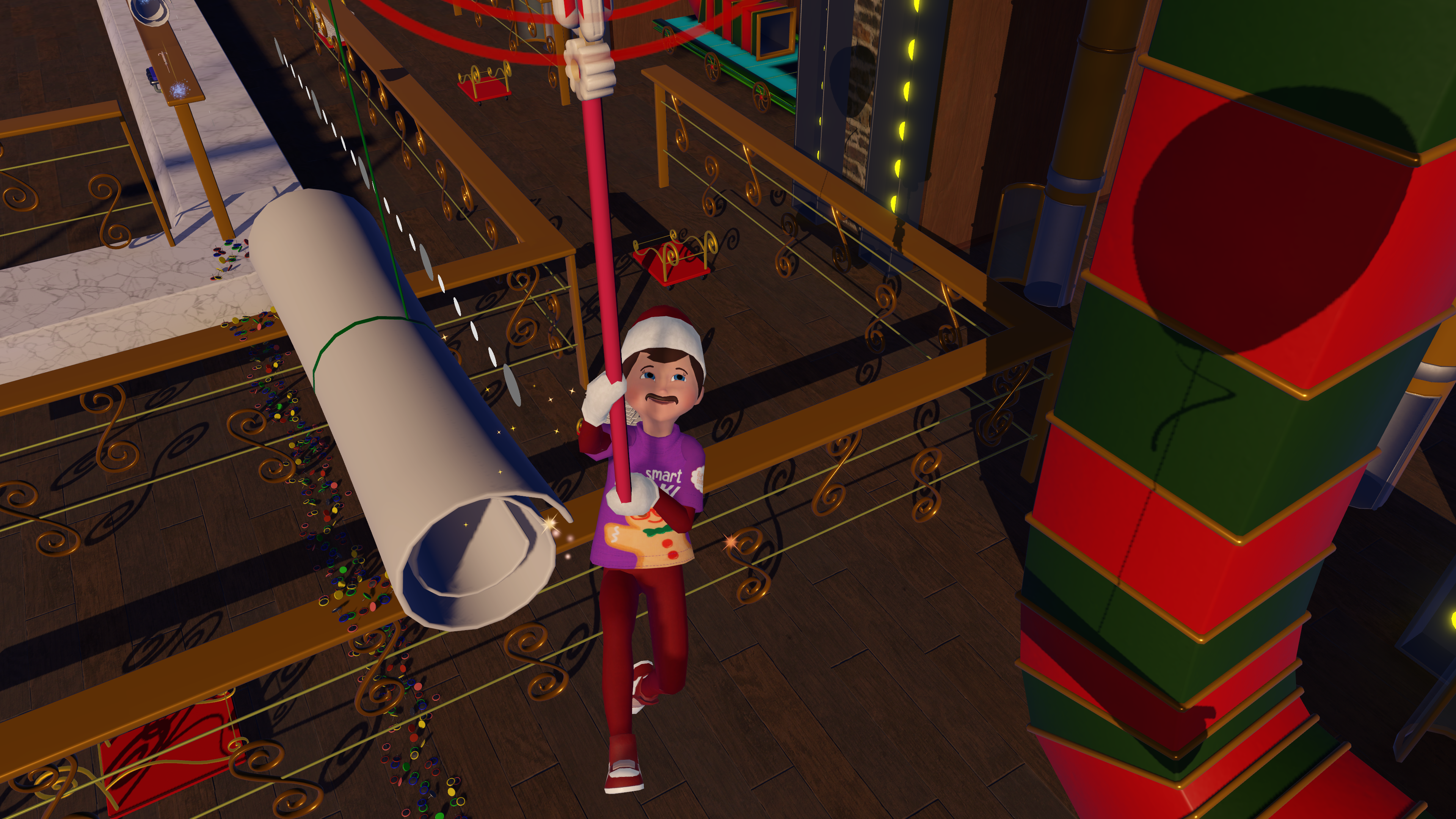Un niño con gorro de Papá Noel sostiene un poste, de pie sobre un área decorada. Hay un rollo grande en la escena. El fondo es festivo.
