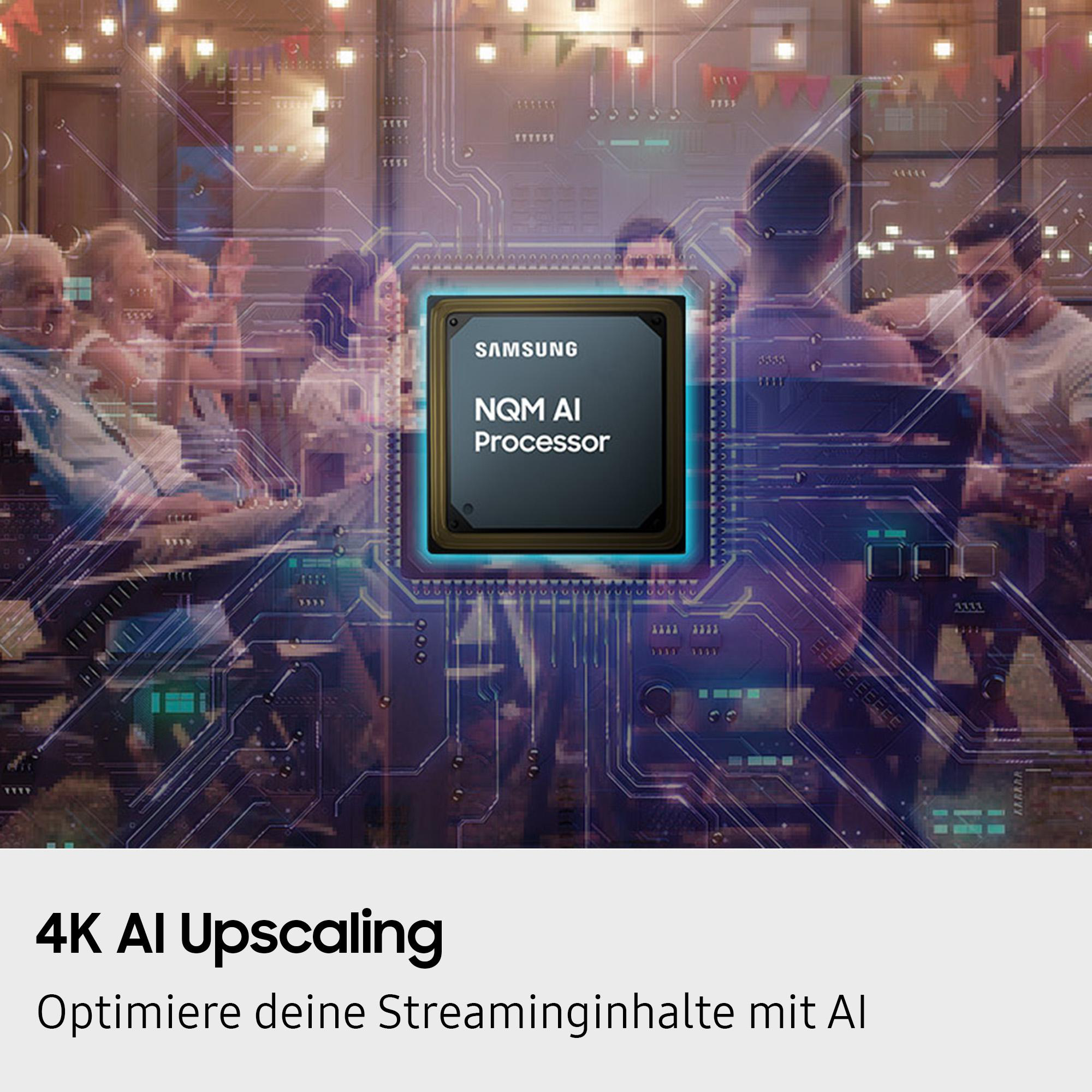 Das Bild zeigt Menschen in der Nähe eines Samsung-Prozessors. Der Text lautet 4K AI Upscaling. Menschen sind im Hintergrund.