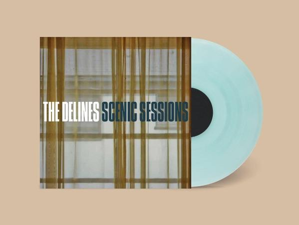 Albumcover für The Delines Scenic Sessions. Zeigt eine hellblaue Schallplatte neben einem Fenster mit dem Albumtitel.