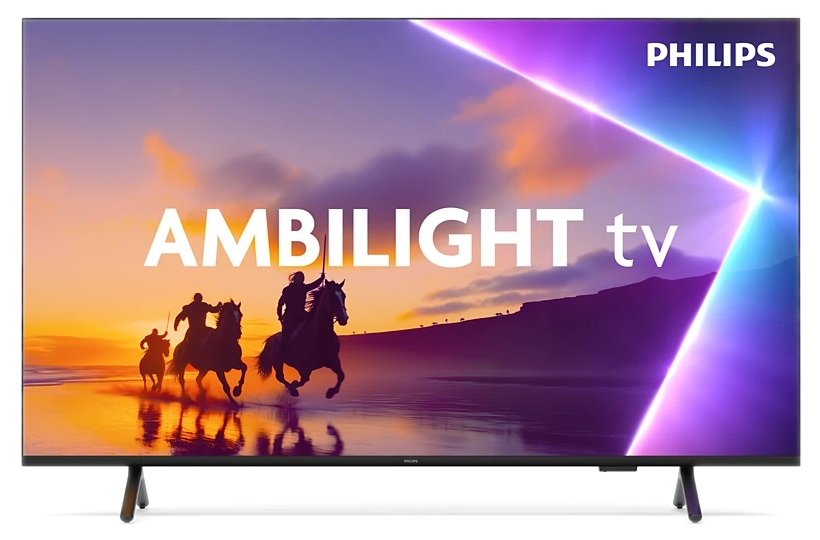 Telewizor Philips Ambilight. Trzech jeźdźców na koniach na plaży. Tło zachodu słońca w kolorach fioletowym i pomarańczowym.