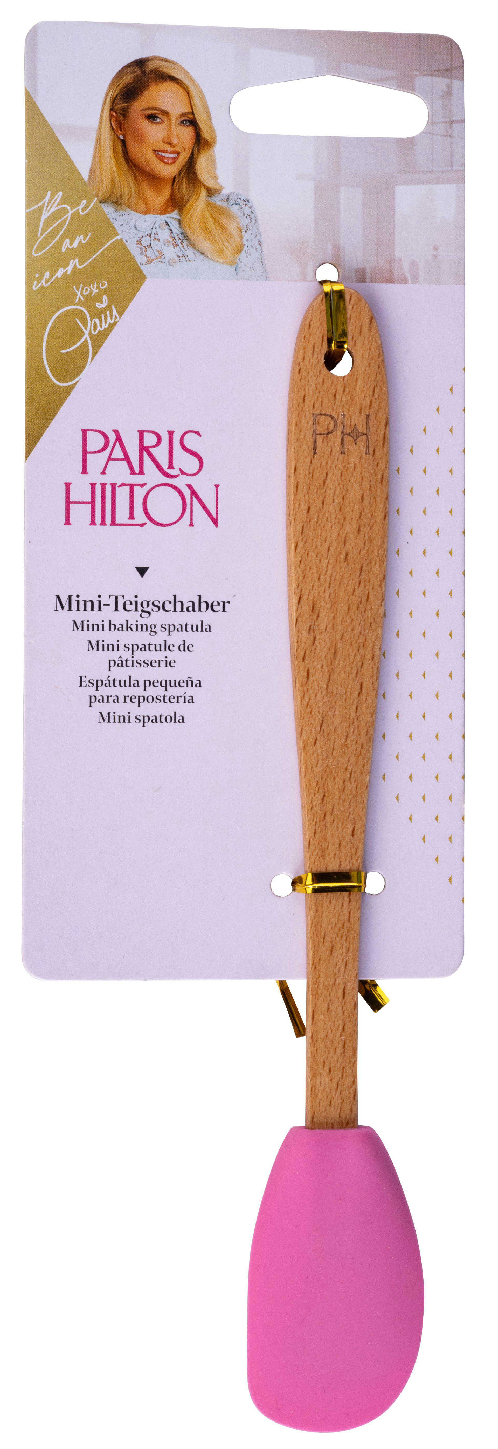 Eine Mini-Spachtel der Marke Paris Hilton. Der Spatel hat einen Holzgriff und einen rosa Silikonkopf. Die Verpackung hat das Paris Hilton Logo.