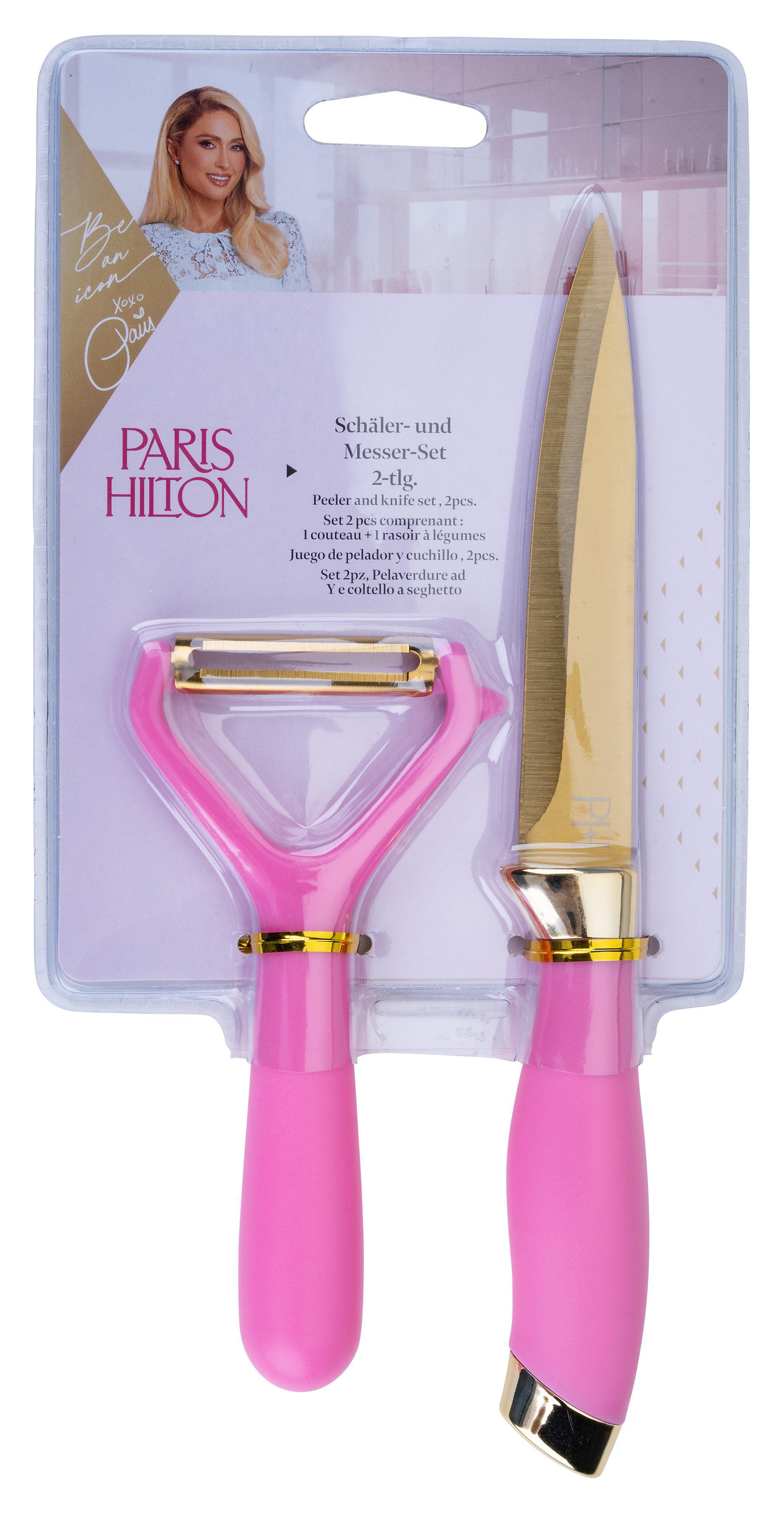 Ein pinkfarbenes und goldenes Messer- und Schäler-Set in einer Kunststoffverpackung mit Paris Hiltons Bild. Aufschrift 'Schäler- und Messer-Set'.