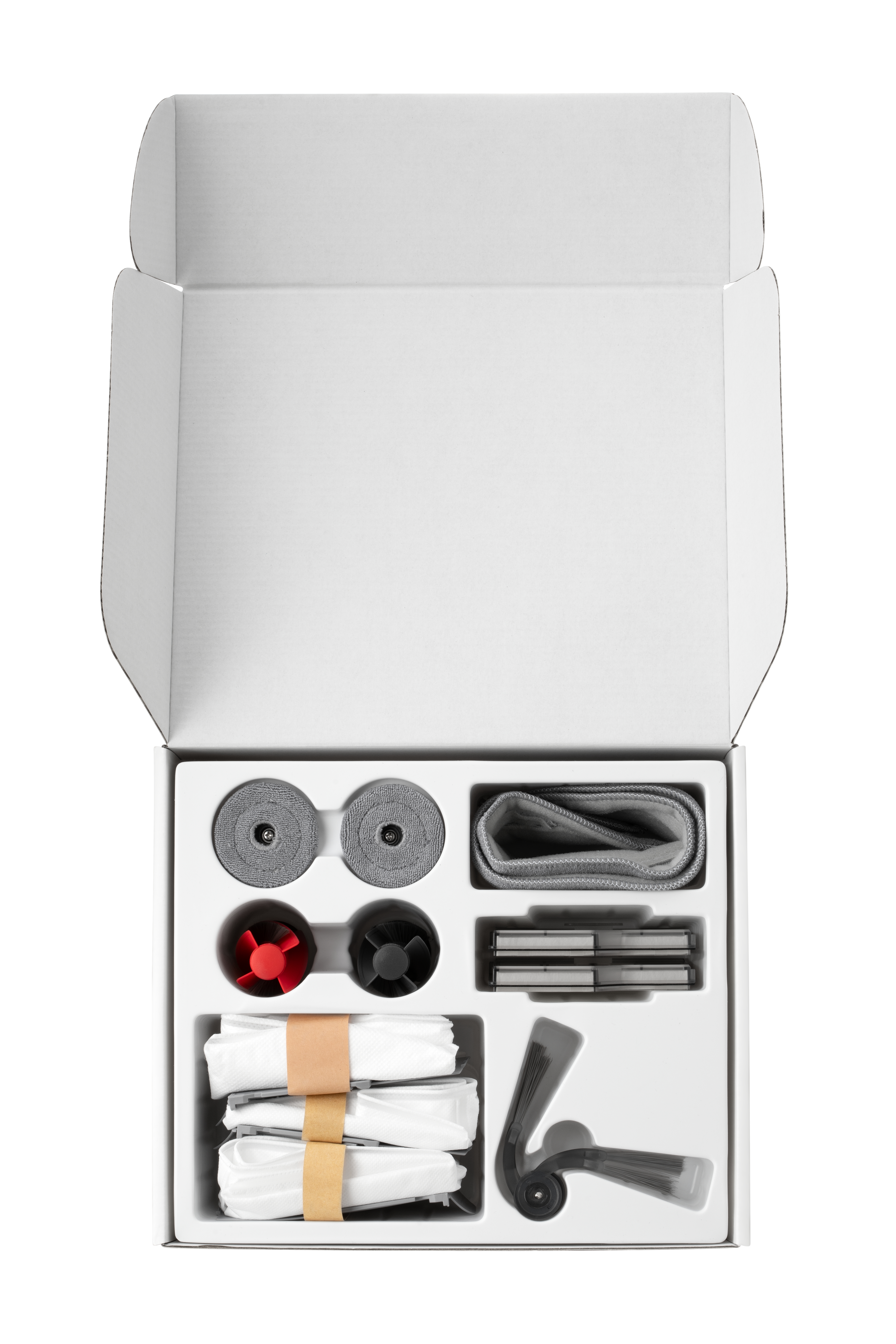 Offene weiße Box mit Fächern. Enthält graue Rollen, rote und schwarze Bürstenköpfe, Filter und Reinigungspads.