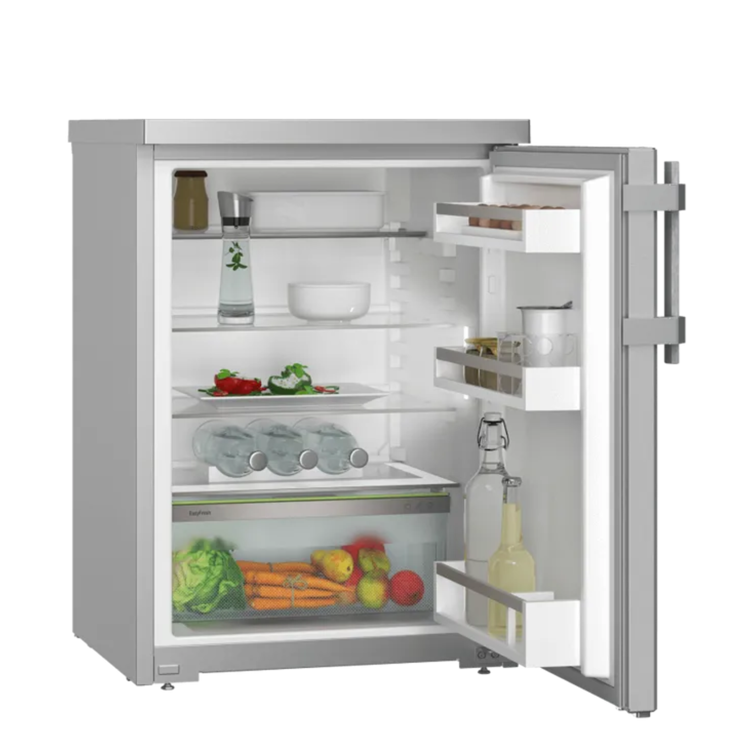 Open fridge. Inside are fruits, vegetables, bottles, and containers. The door is open, revealing shelves and contents.