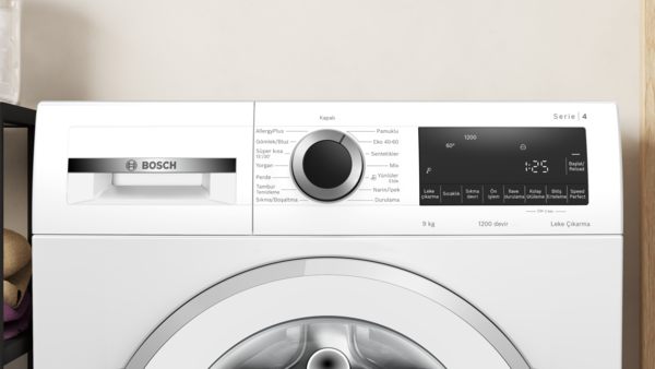 Beyaz bir Bosch çamaşır makinesi. Dijital bir ekranı ve merkezi bir kadranı var.