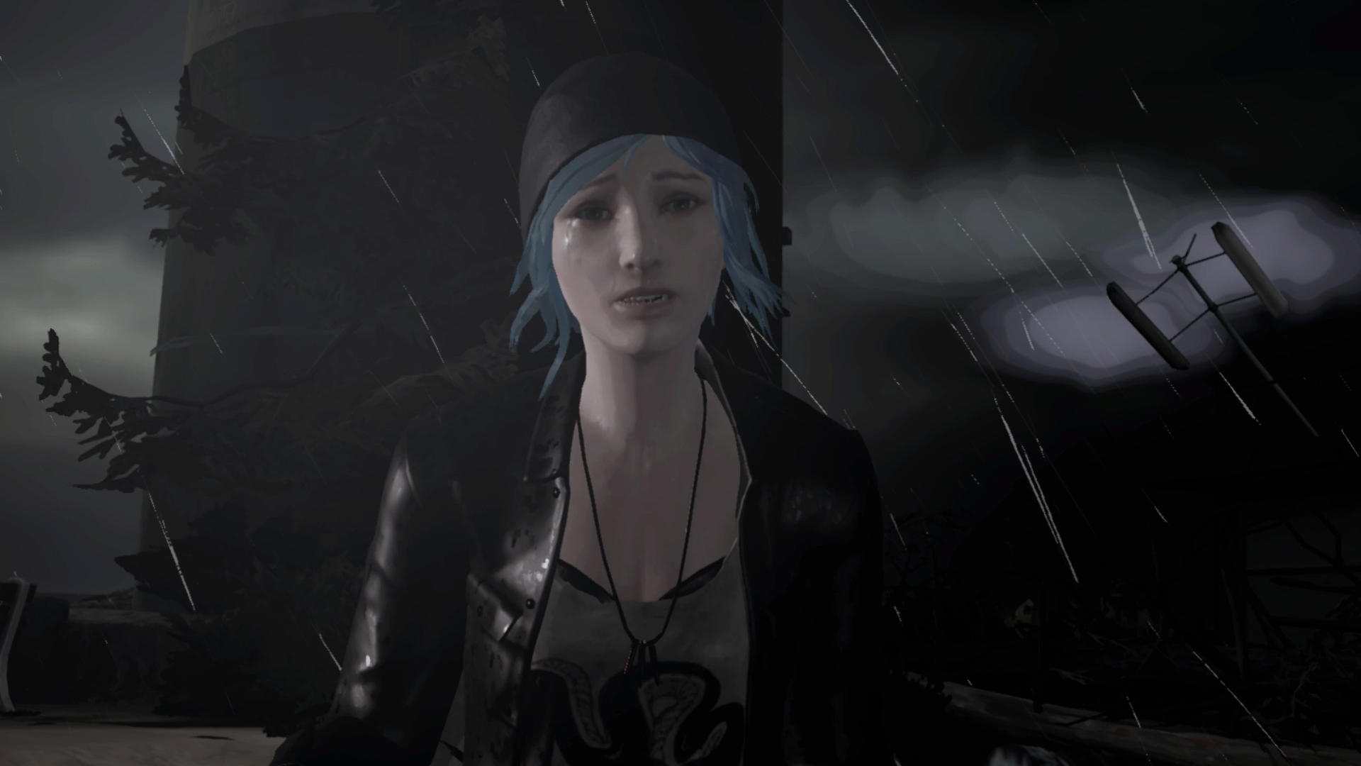Eine weinende Frau mit blauen Haaren in einer schwarzen Jacke steht im Regen. Dunkler Hintergrund mit Turm und Stromleitungen.