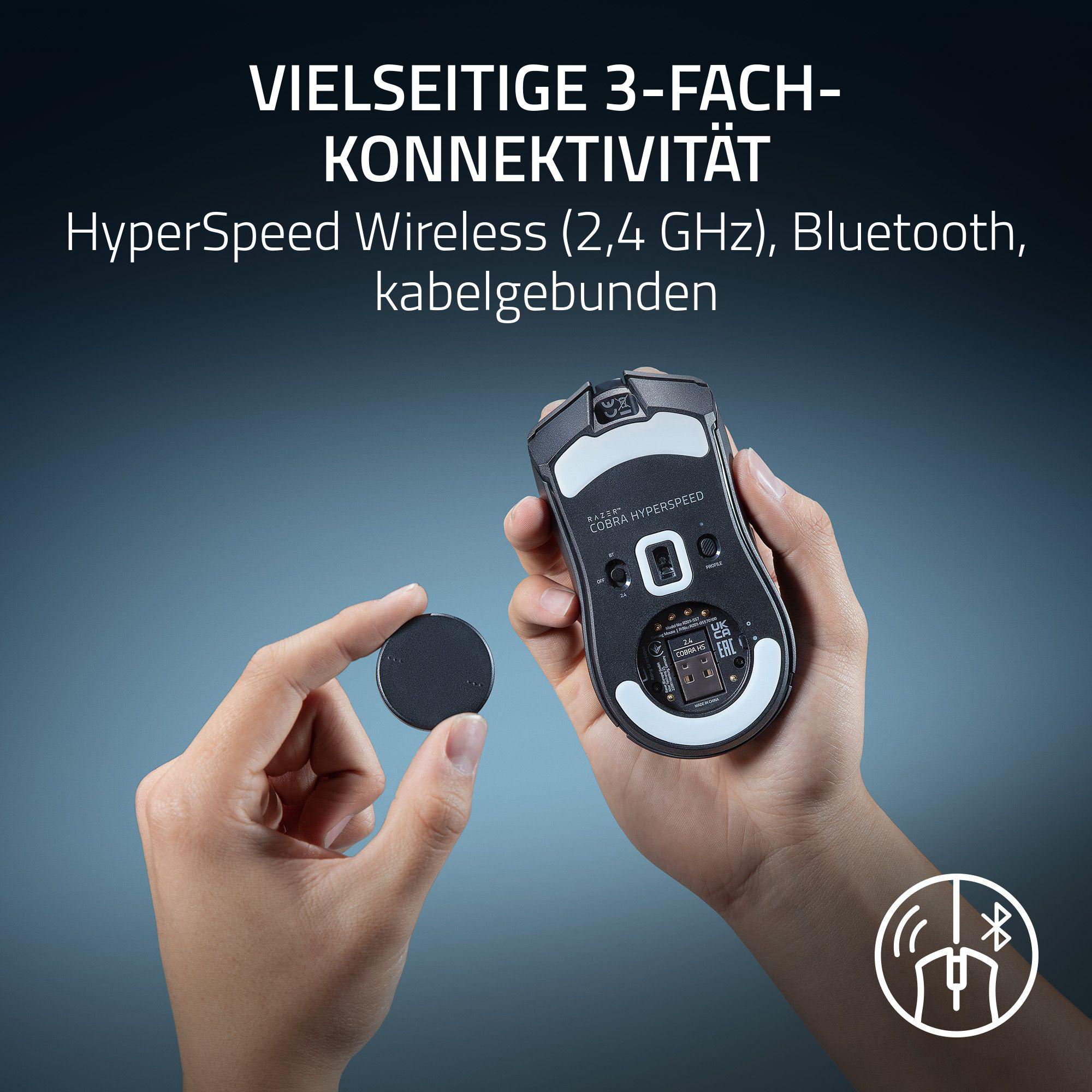 Hände halten schwarze Razer-Maus und rundes Teil. Text zur Konnektivität ist sichtbar.
