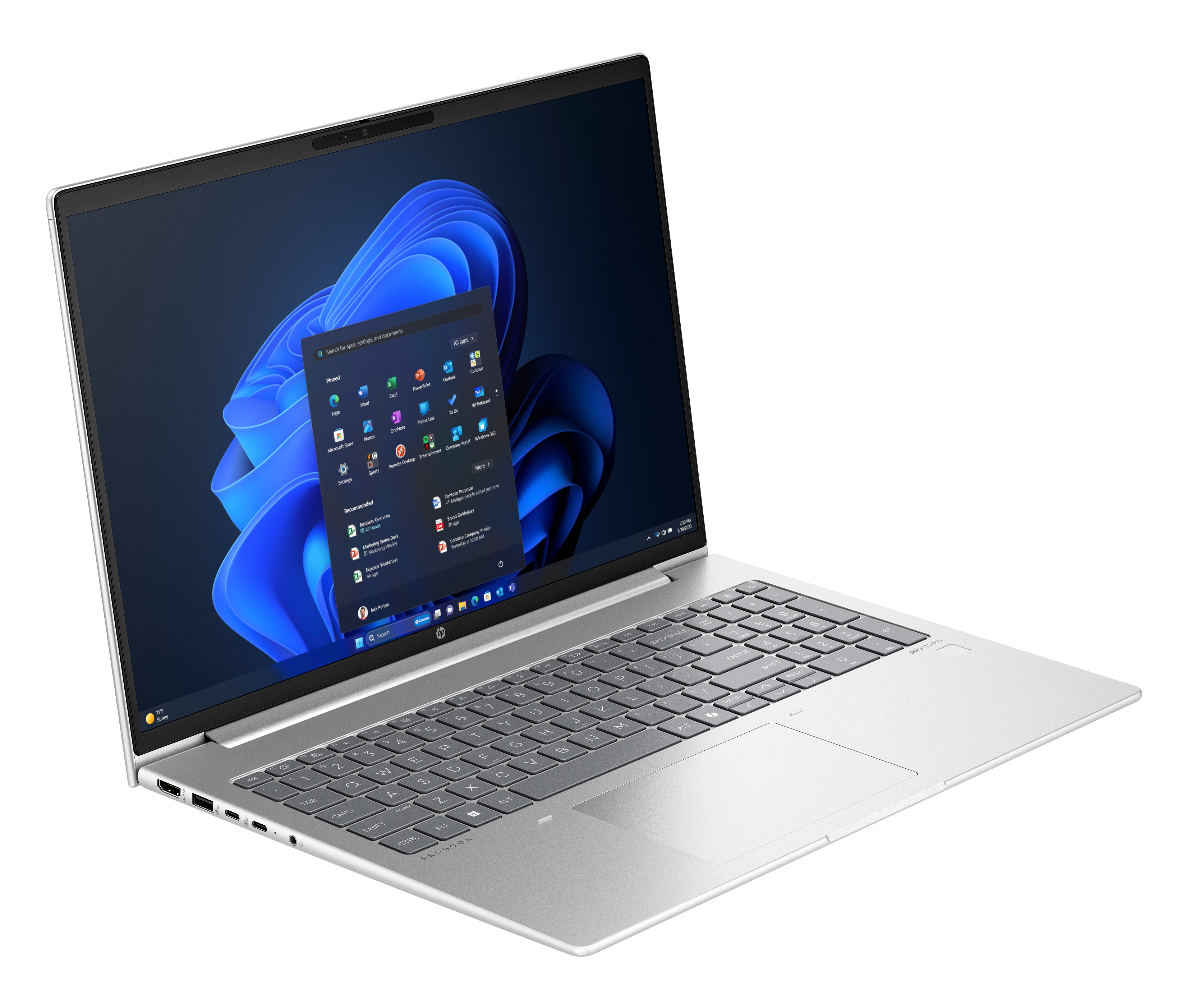 Srebrny laptop na czarnym tle. Ekran pokazuje interfejs Windows 11 z aplikacjami.