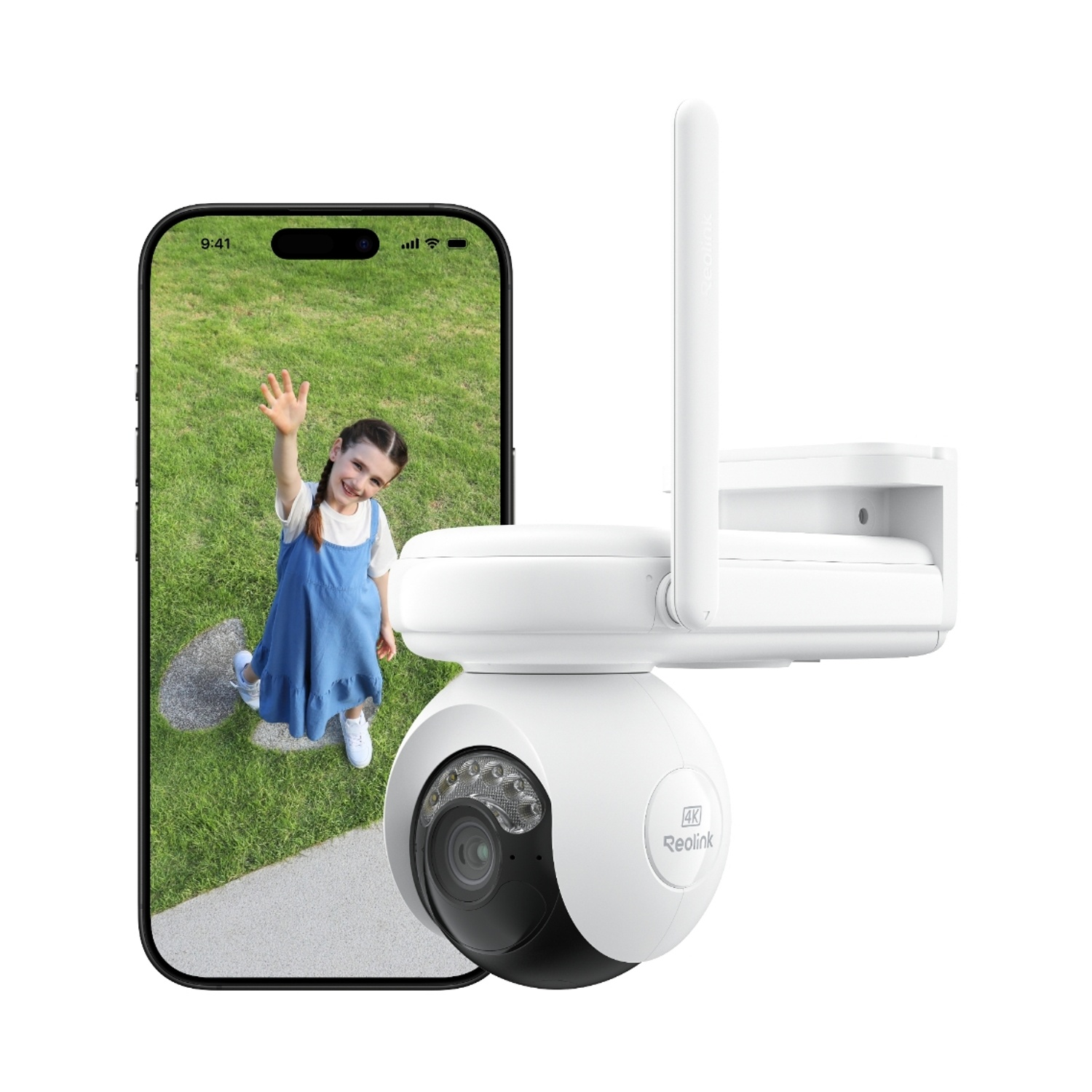 Un telefono mostra una bambina che saluta in un giardino verde. A destra c'è una telecamera di sicurezza bianca con antenna.