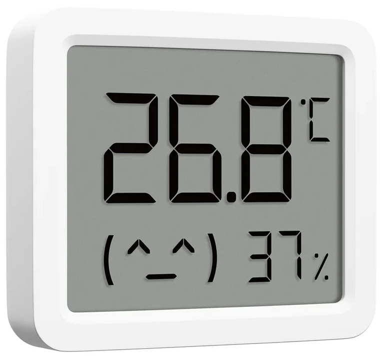 Digitális hőmérő 26,8°C-ot és 37% páratartalmat mutat, smiley-val. A készülék fehér keretben van.
