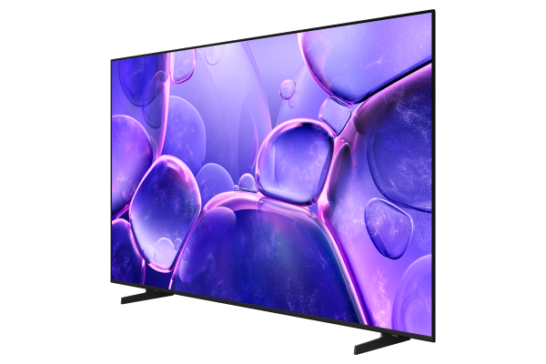 Modern bir TV, mor, soyut, kabarcık benzeri bir tasarım sergiliyor. Siyah bir stant üzerinde ve siyah bir çerçeveye sahip, siyah bir arka plan üzerinde.