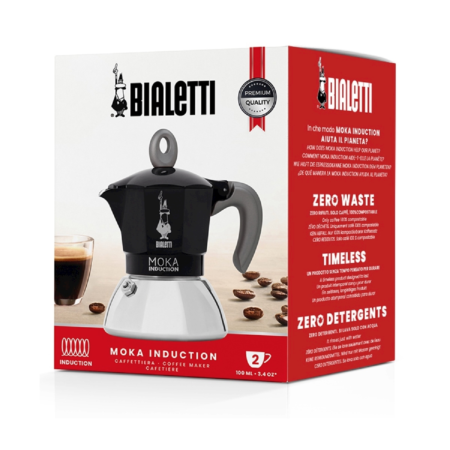 Una caffettiera Bialetti Moka Induction nera e argento con una tazza di caffè e chicchi di caffè.