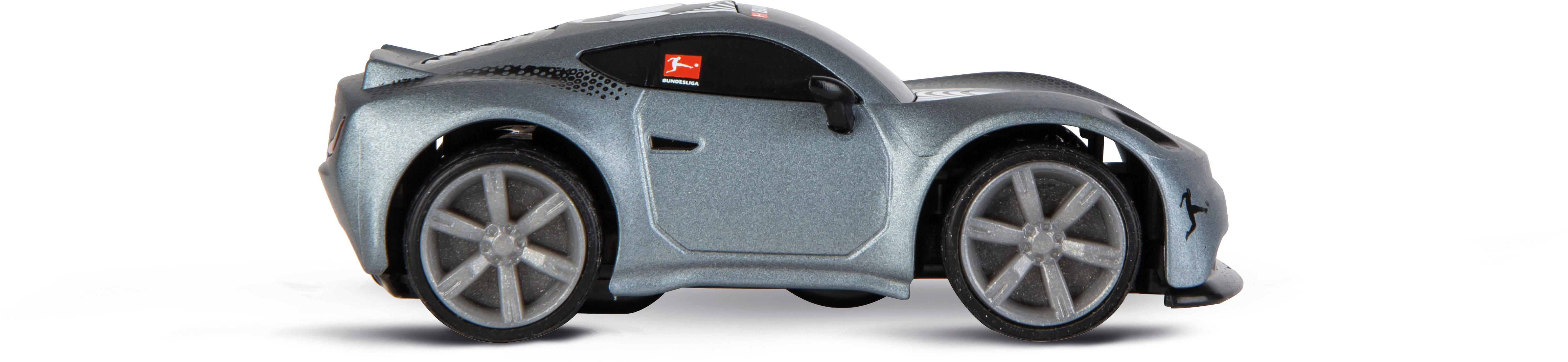 Ein silbernes Spielzeugauto mit schwarzen Rädern. Es hat das Bundesliga-Logo an der Seite. Der Hintergrund ist weiß.