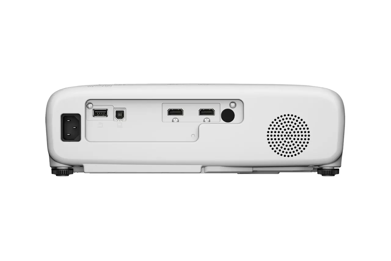 Fehér projektor hátulja, hálózati bemenettel, USB-portokkal, HDMI-portokkal, kerek hangszóróval és állító lábakkal.