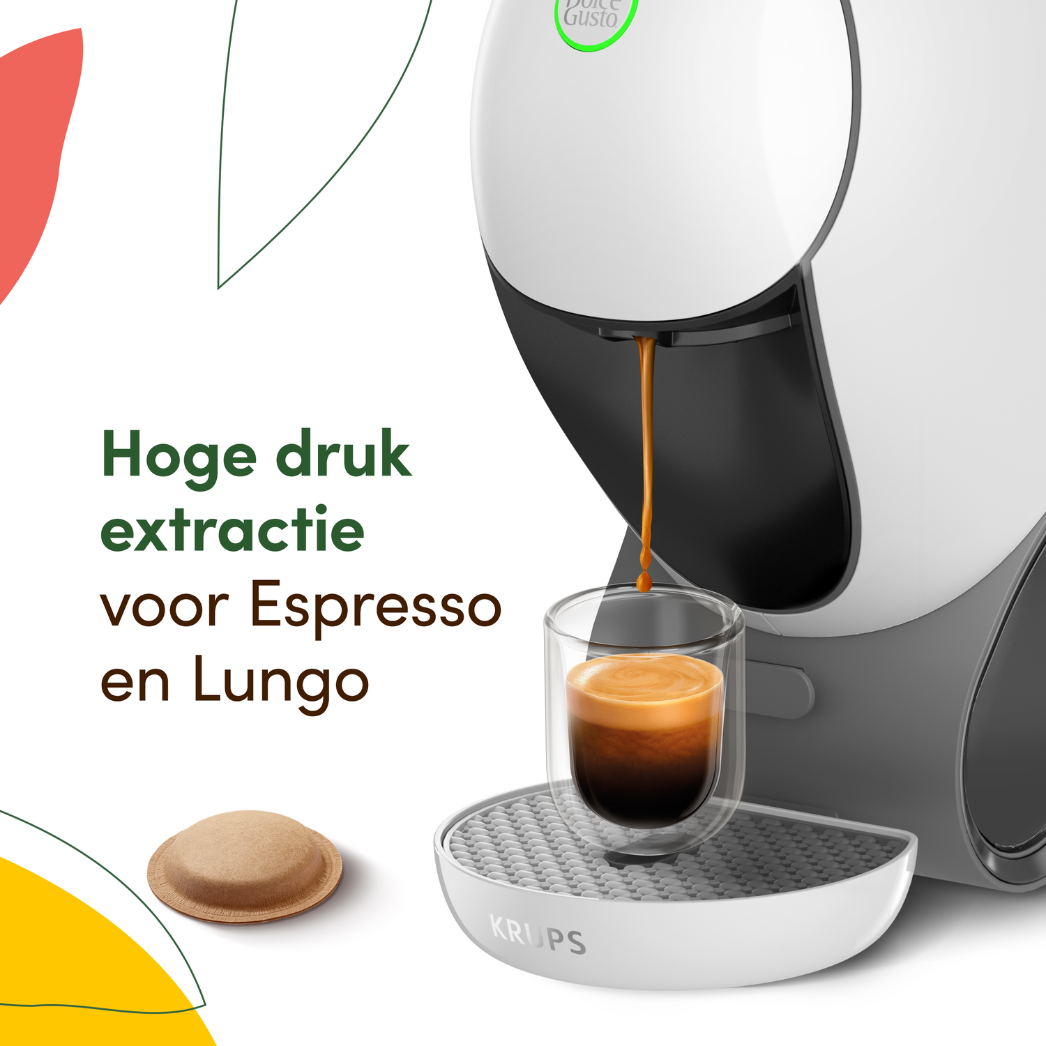 A white coffee machine dispenses espresso into a glass. A coffee pod and text are also visible. The machine has a grey base.