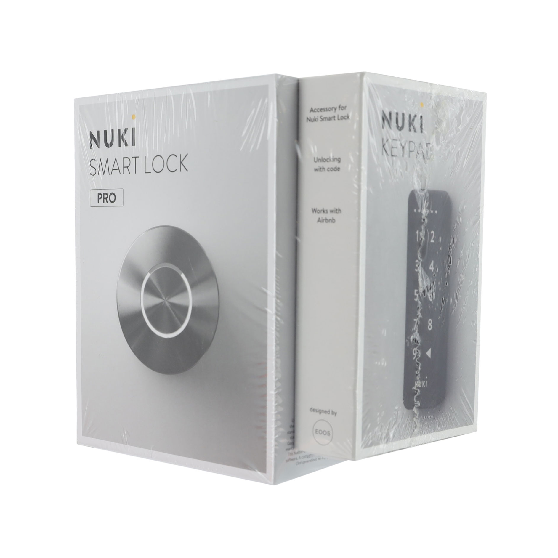 Dos cajas Nuki Smart Lock juntas. Una caja tiene un diseño de cerradura plateada, la otra un teclado numérico.