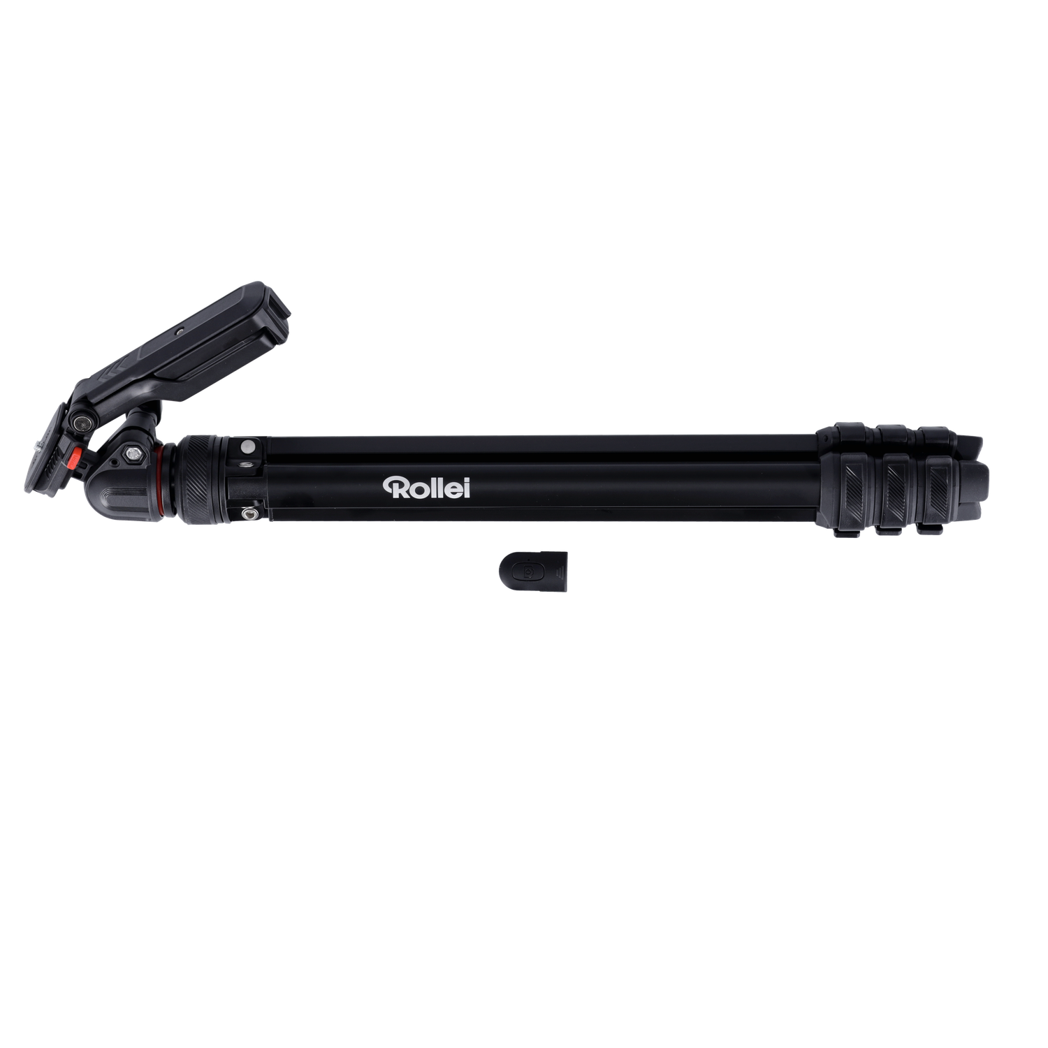 A black Rollei tripod lies on a black background. The tripod is extended. A small piece of the tripod is next to it.