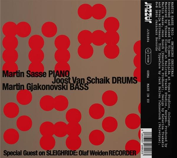 Albumcover mit roten Kreisen auf braunem Hintergrund. Text enthält Künstlernamen und Albumtitel.