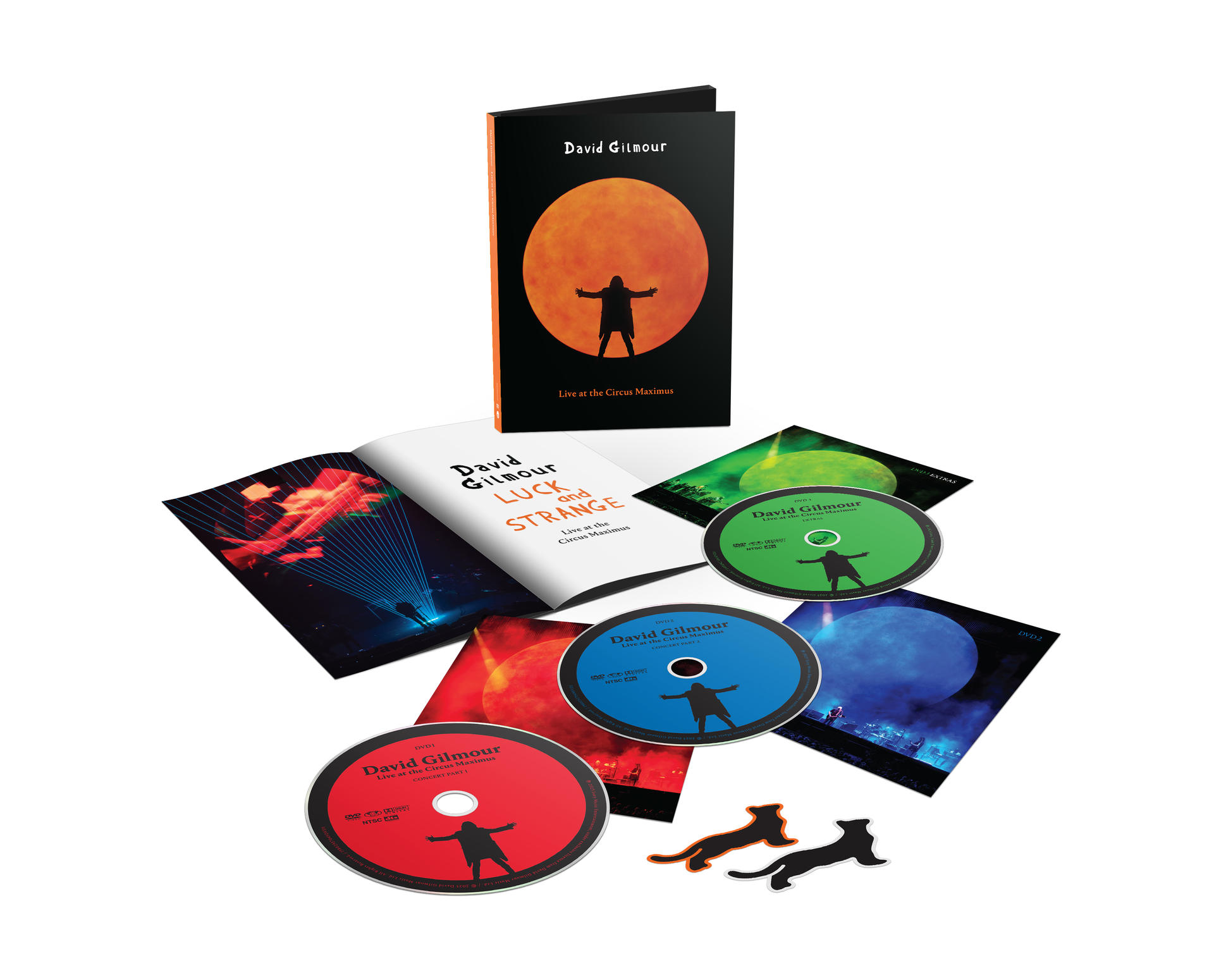 CDs, booklets, and stickers for David Gilmour's "Luck and Strange" album. Silhouettes of a person with open arms are on them.