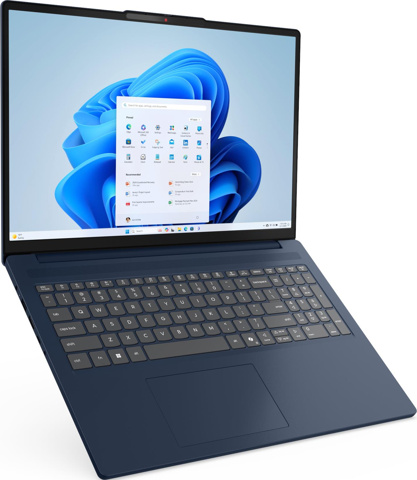 Un ordinateur portable bleu affiche l'interface Windows 11. Le clavier est visible. L'écran montre des icônes d'applications et une barre de recherche.