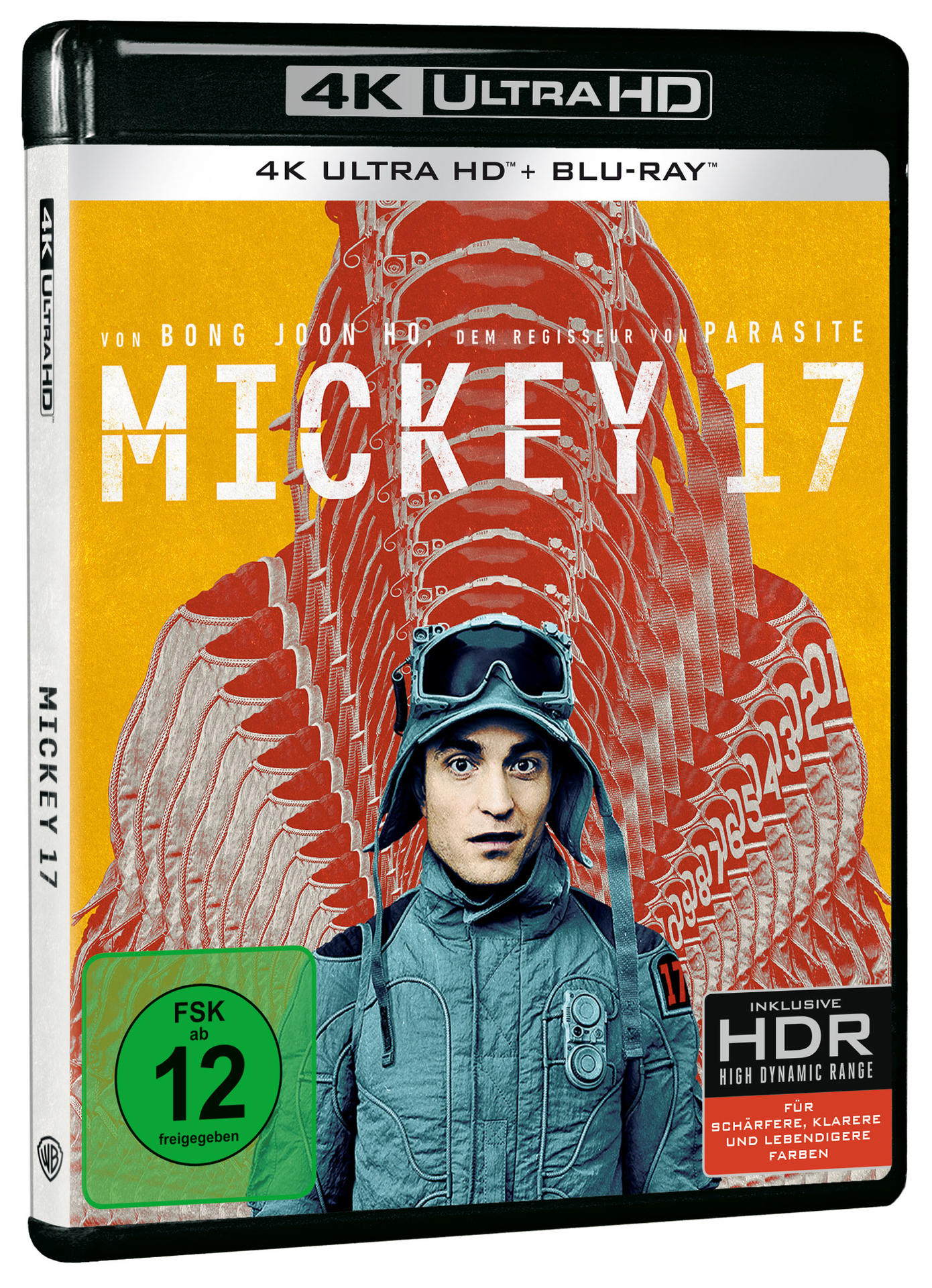Mickey 17 Blu-ray-Cover. Ein Mann im Raumanzug ist das Hauptmotiv. Der Hintergrund ist orange mit roten flügelartigen Designs.