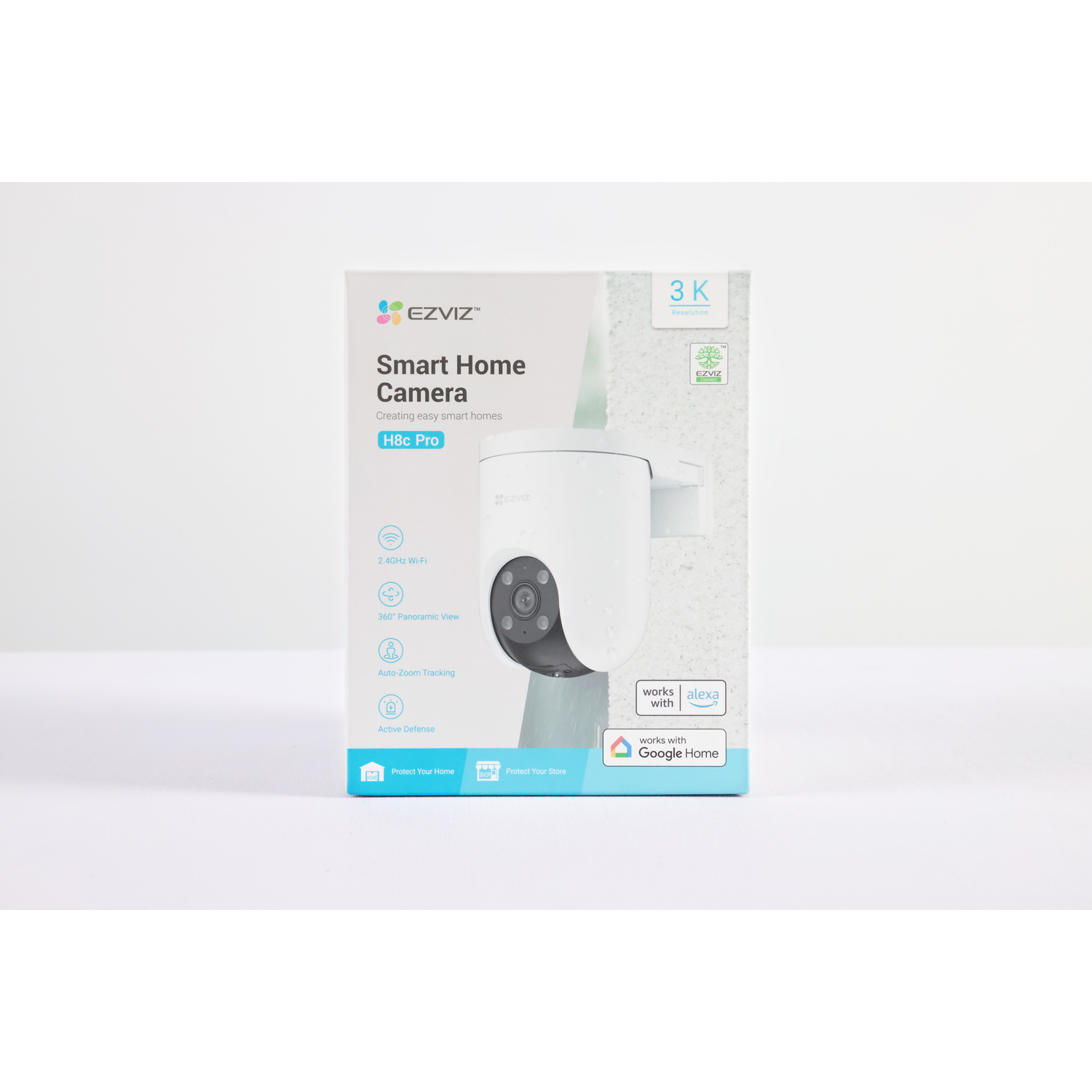 A white EZVIZ H8c Pro smart home camera is on a box. Features include 3K resolution, Wi-Fi, panoramic view, auto-zoom, and active defense.