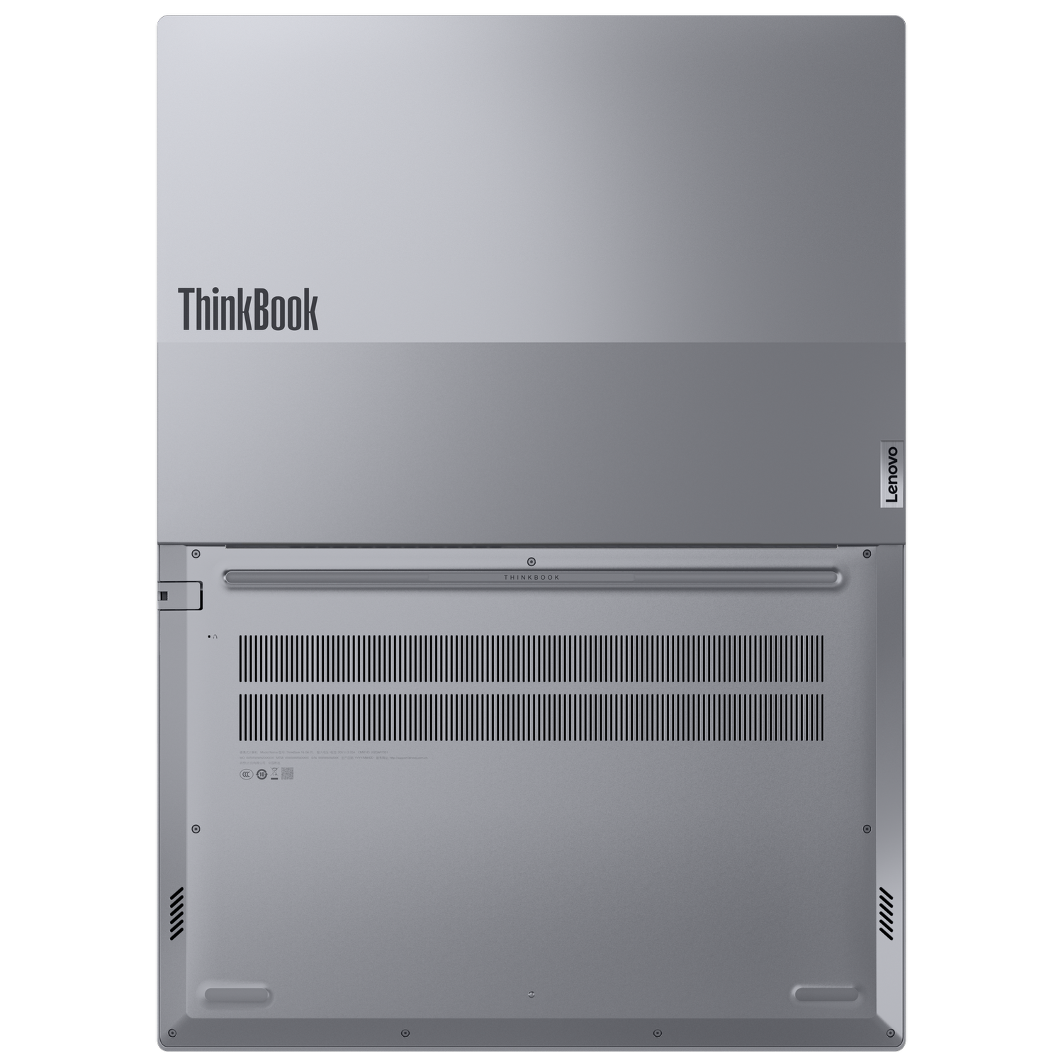 Srebrny laptop ThinkBook, widok od spodu. Logo Lenovo po prawej. Widoczne otwory wentylacyjne, śruby i inne szczegóły.