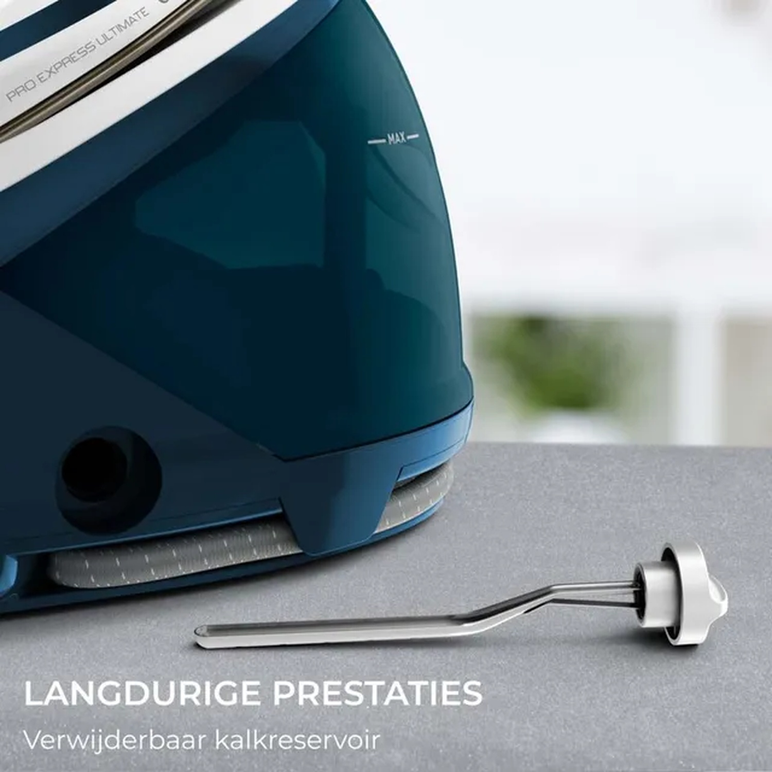 A close-up of a dark blue steam iron and its removable descaling component on a gray surface. The iron is partially visible.