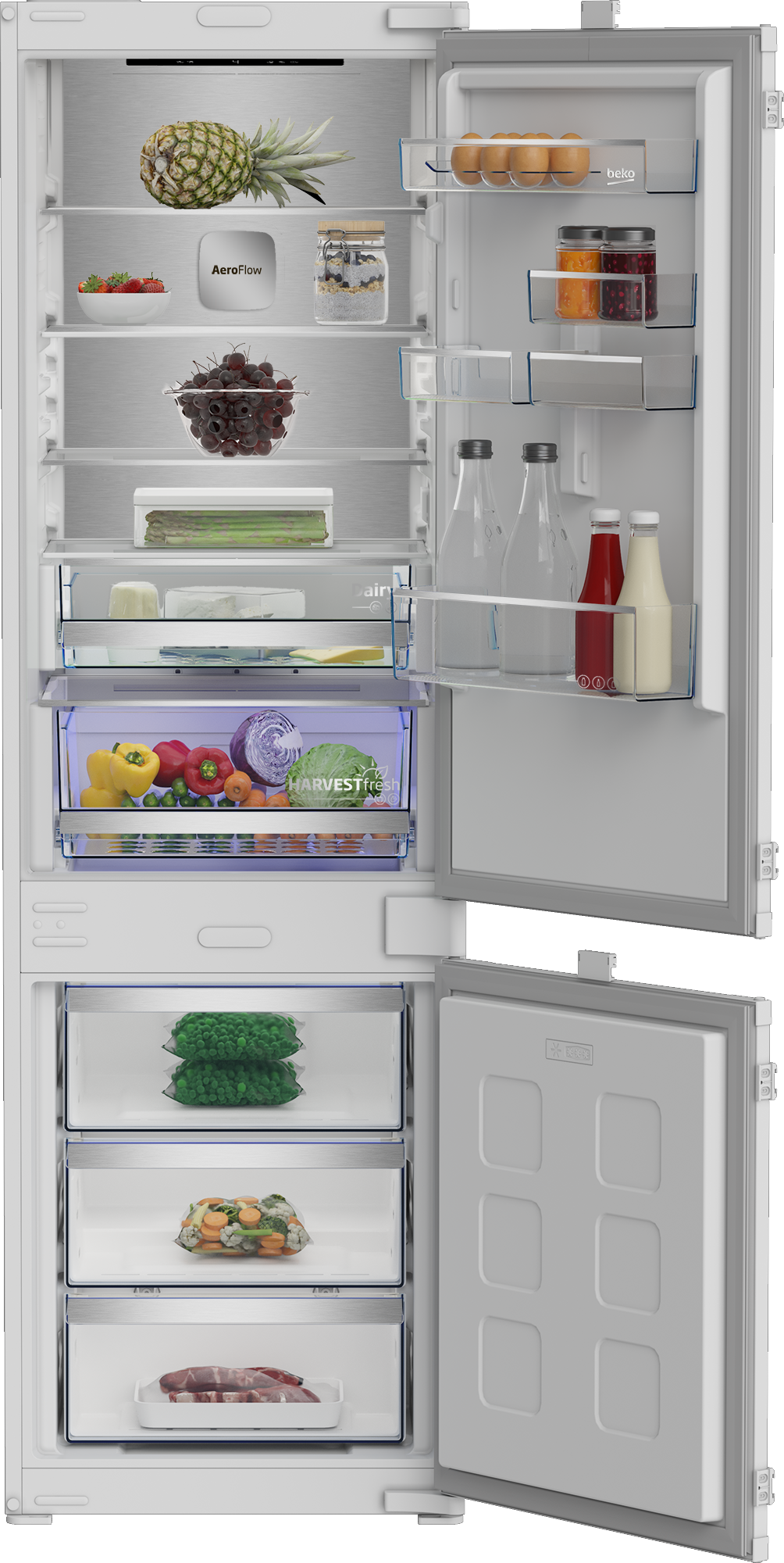 Otwarta lodówka. Widoczne: ananas, truskawki, winogrona, warzywa, jajka, słoiki, butelki i mrożonki.