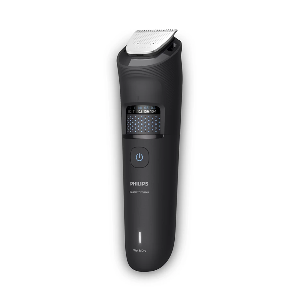 Egy fekete Philips szakállvágó. Digitális kijelzővel rendelkezik, amelyen a hosszbeállítások láthatók, van egy bekapcsológomb, és a 'Wet & Dry' felirat.