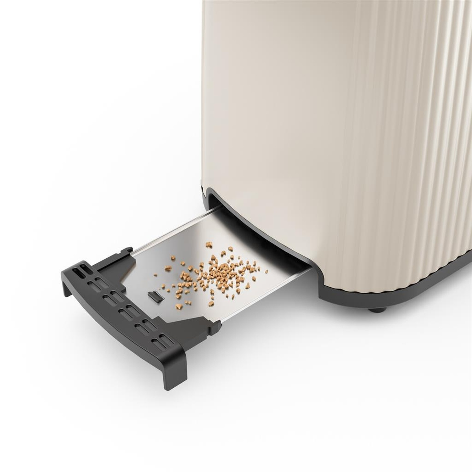 A beige toaster with a crumb tray. Crumbs are visible. The toaster has vertical ribbed detailing.