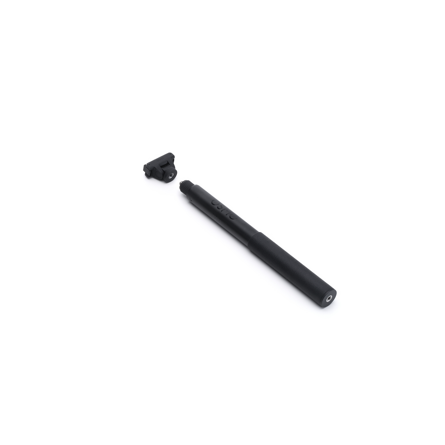 A black pen-like object lies on a white background. A piece of the pen is detached. The word 'OSMO' is visible on the pen.