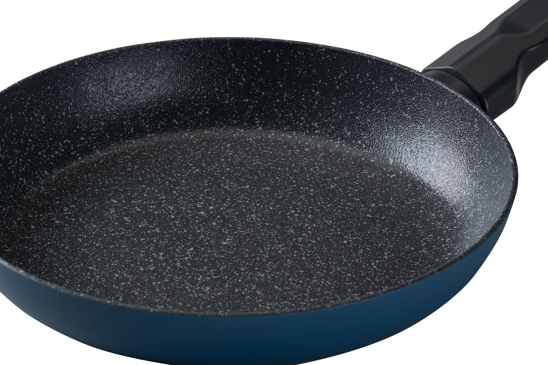 Eine blaue Bratpfanne mit schwarzem, gesprenkeltem Innenraum und schwarzem Griff, isoliert auf weißem Hintergrund.