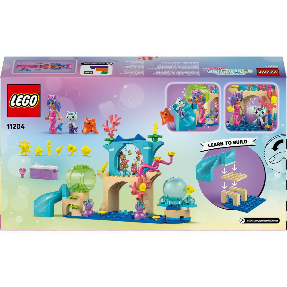 Lego-Box mit Meerjungfrau-Figuren, Katzenfiguren und Korallen. Enthält eine blaue Rutsche und einen Bausatz. Das Lego-Logo ist sichtbar.