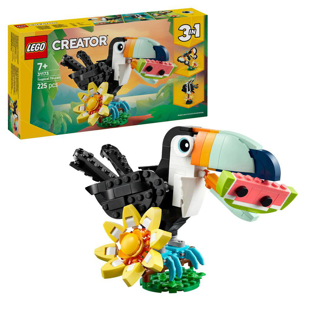 Ein Lego Creator-Set mit einem Tukan, der eine Wassermelone hält. Das Set steht auf einer grasbewachsenen Basis mit einer gelben Blume.