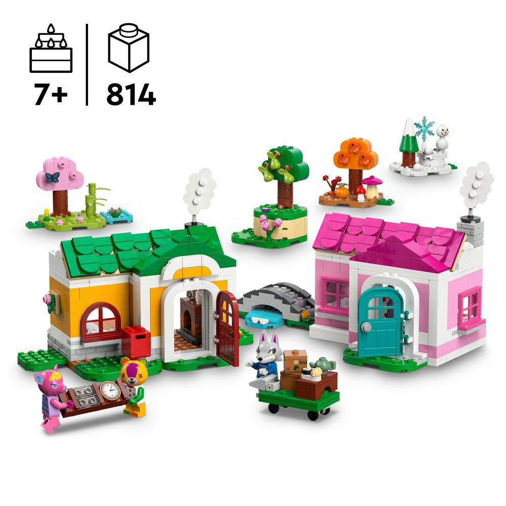 Lego-Set mit zwei Häusern, verschiedenen Bäumen, einem Schneemann und Tierfiguren, darunter eine Katze und ein Kaninchen, auf weißem Hintergrund.