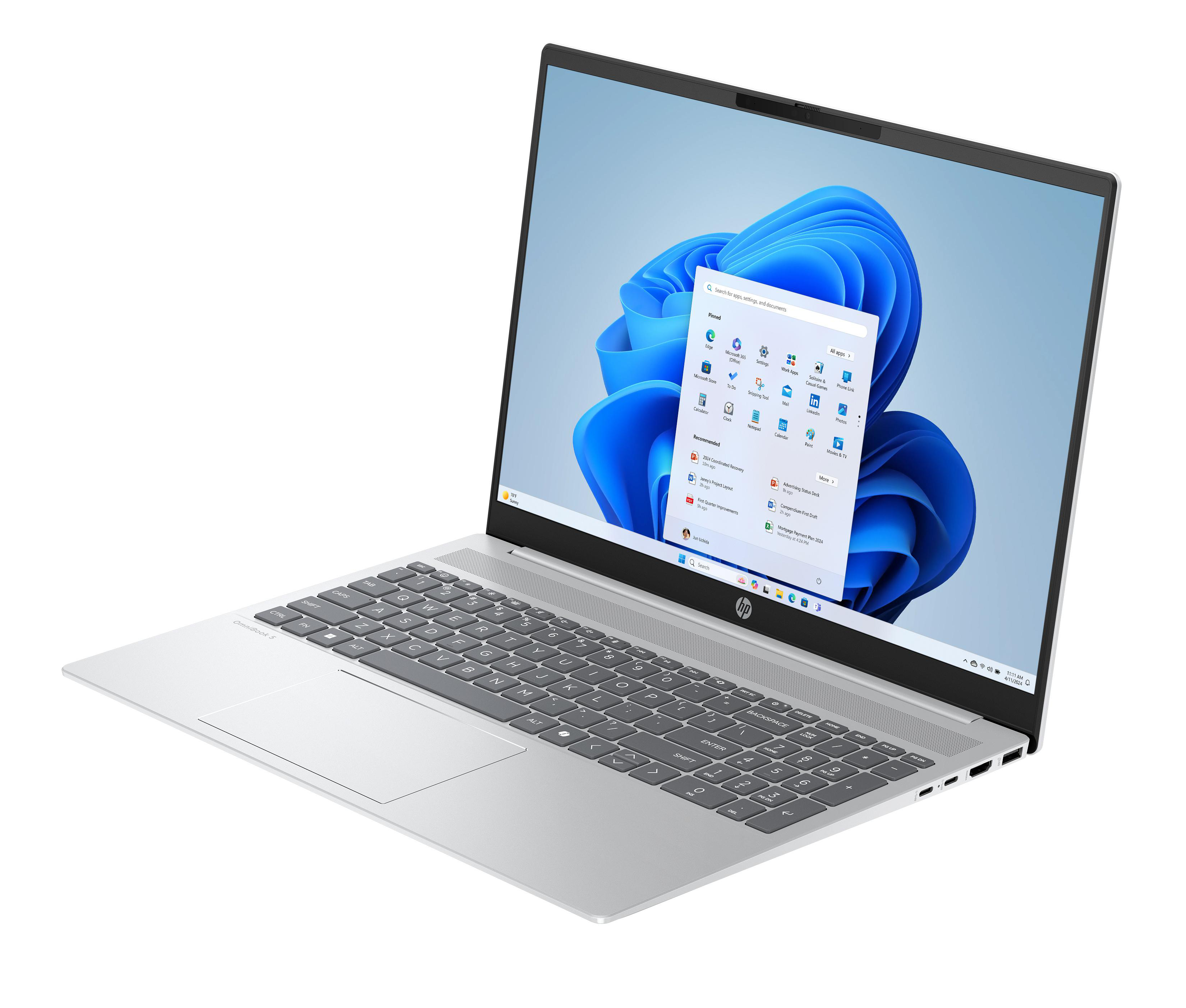 Silberner Laptop, geöffnet, zeigt Windows 11. Tastatur sichtbar. Bildschirm mit blauen, weißen Grafiken.