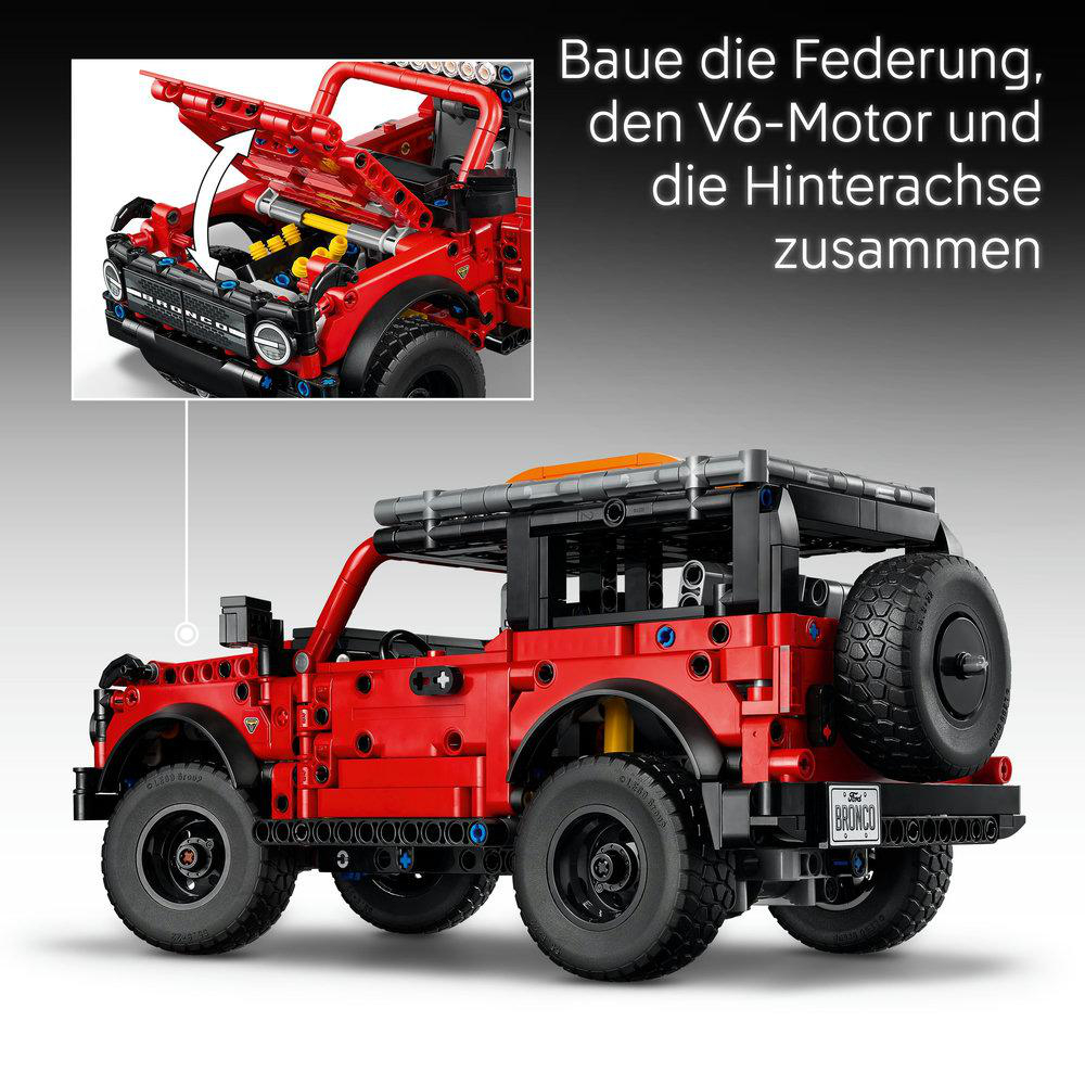 Ein rotes Lego Bronco-Modell wird gezeigt, mit einem inset Bild, das die Motorbaugruppe zeigt. Text auf Deutsch weist auf den Zusammenbau von Federung, Motor und Hinterachse hin.