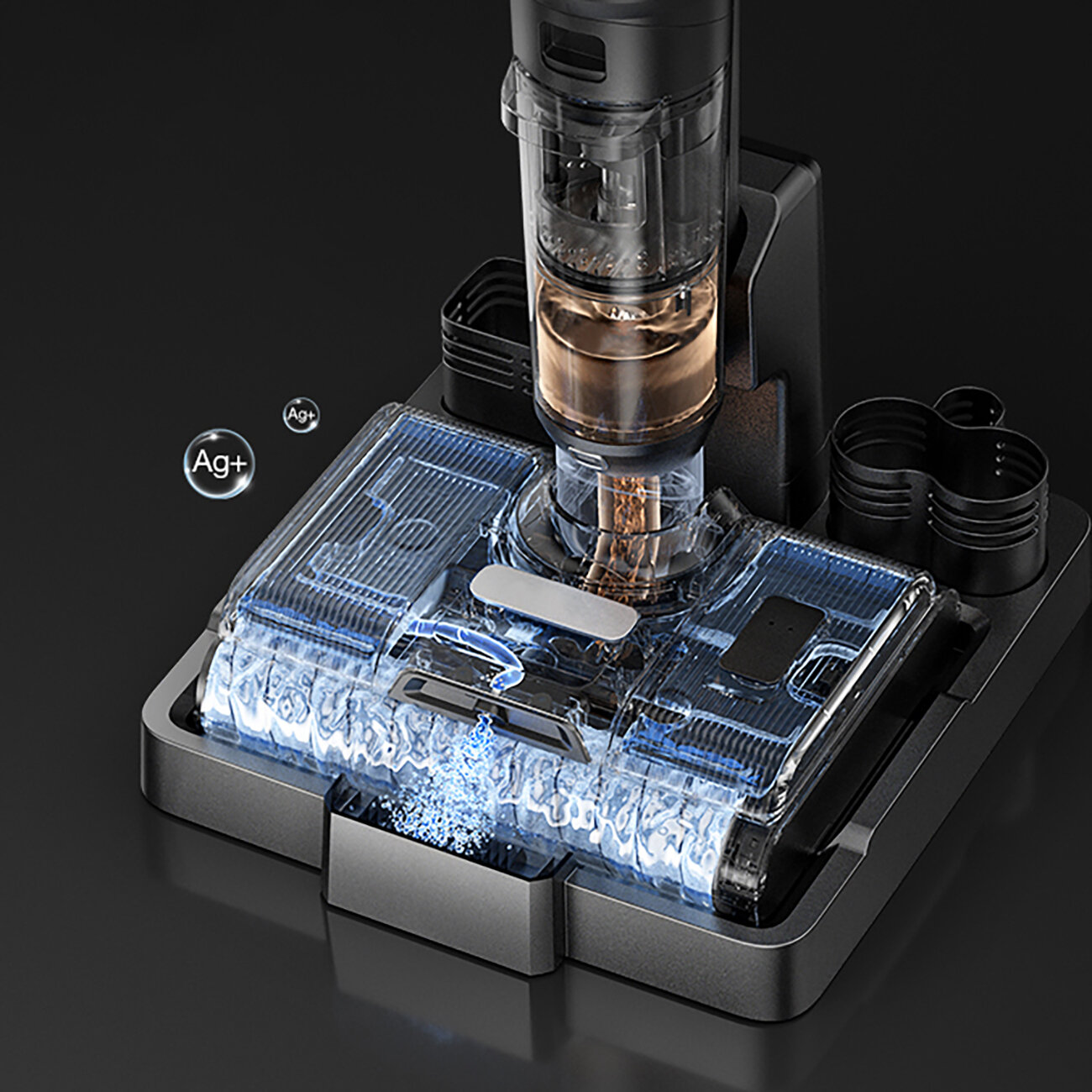 Przezroczysta głowica odkurzacza z podświetlanymi na niebiesko częściami. Srebrne symbole Ag+ po lewej. Czarna podstawa i tło.