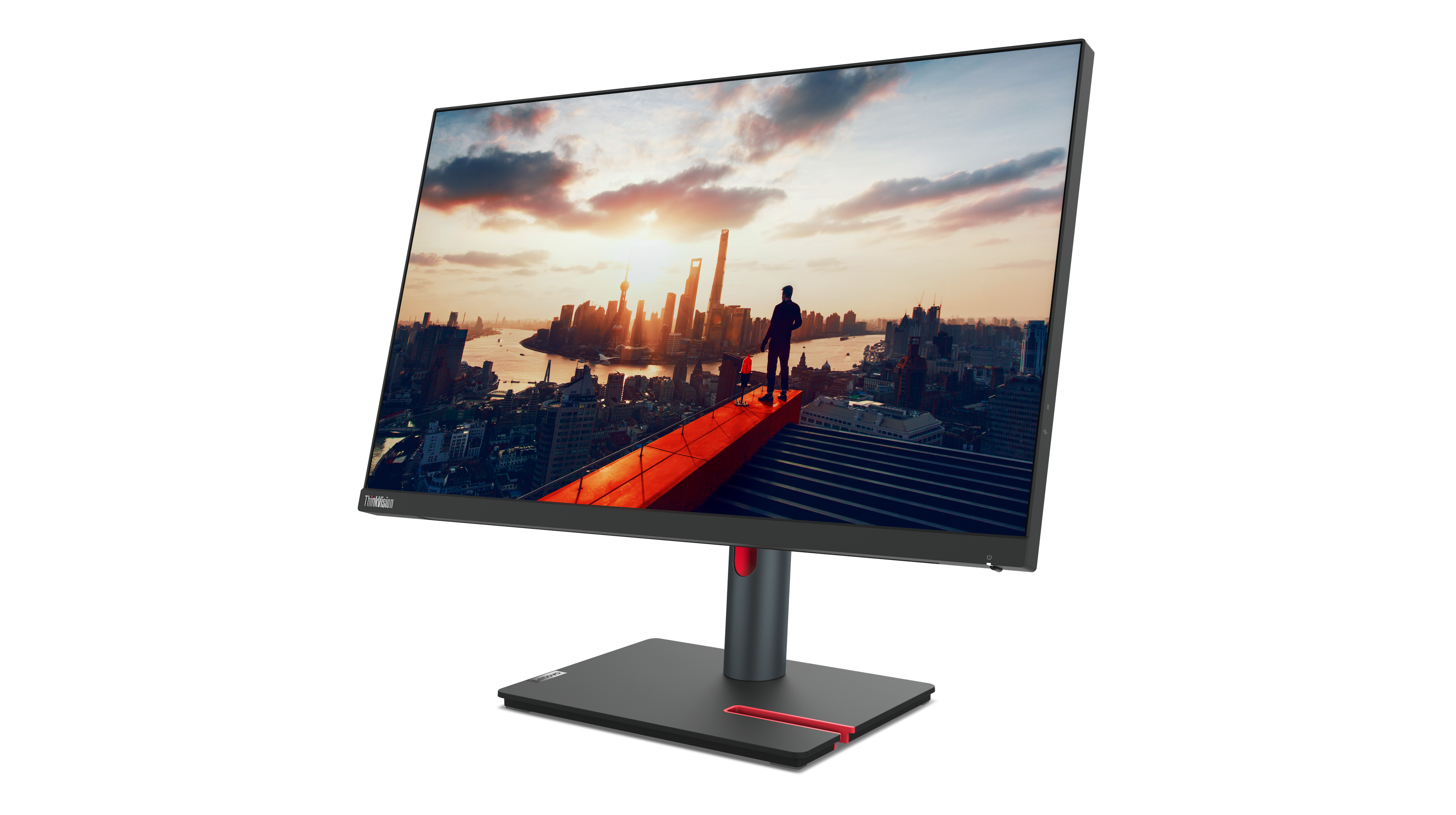 Der Monitor zeigt eine Stadtlandschaft bei Sonnenuntergang. Eine Person steht auf einem roten Weg. Der Monitor ist schwarz mit roten Akzenten.