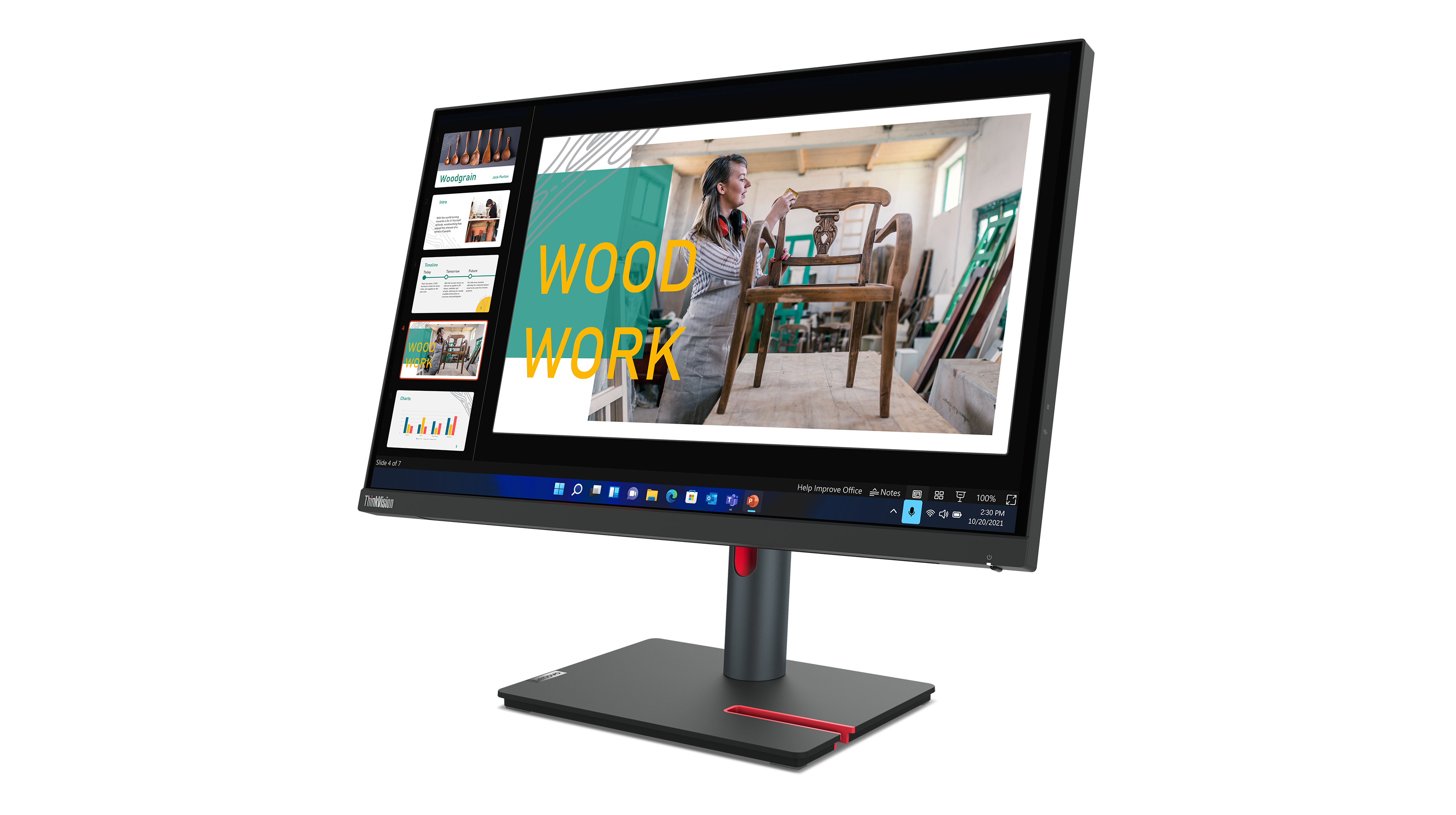 Ein ThinkVision-Monitor zeigt eine Präsentation über Holzarbeiten. Im Hintergrund arbeitet eine Frau an einem Stuhl.