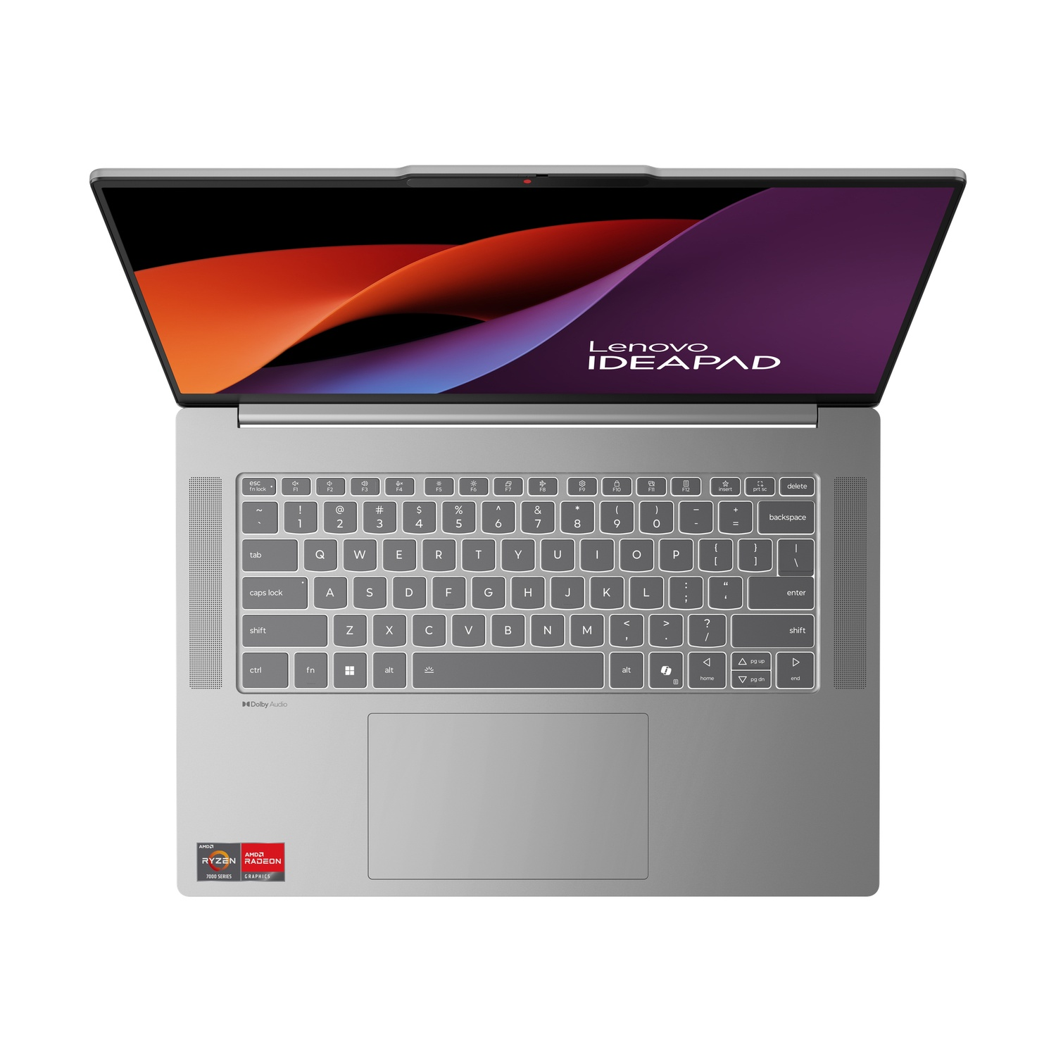 Un ordinateur portable Lenovo IdeaPad argenté. L'écran affiche des formes abstraites. Le clavier est visible, avec un autocollant AMD Ryzen en bas à gauche.