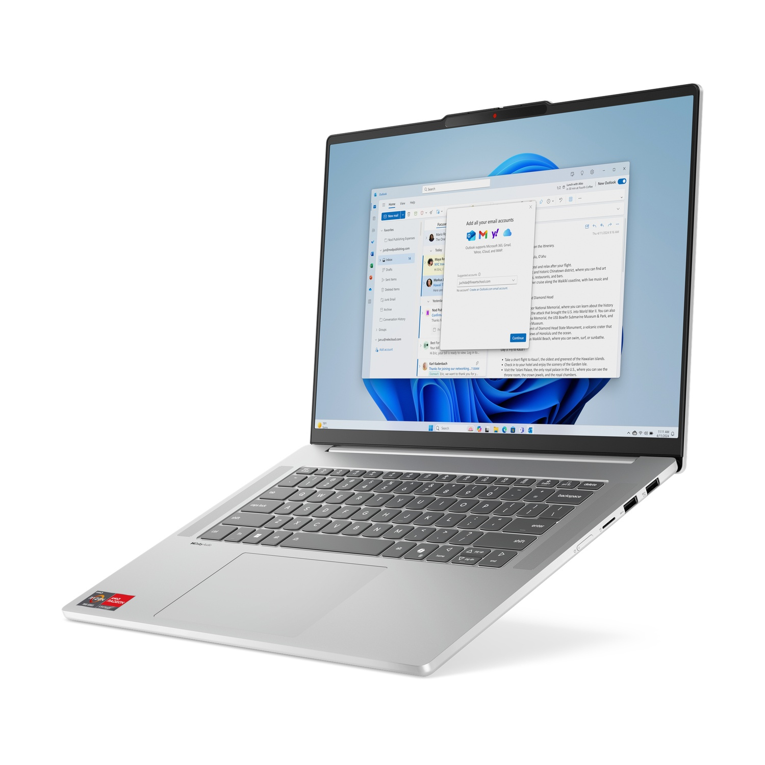 Un ordinateur portable argenté affiche la configuration d'un compte de messagerie. L'écran affiche des e-mails. Un autocollant AMD rouge est sur l'ordinateur portable.