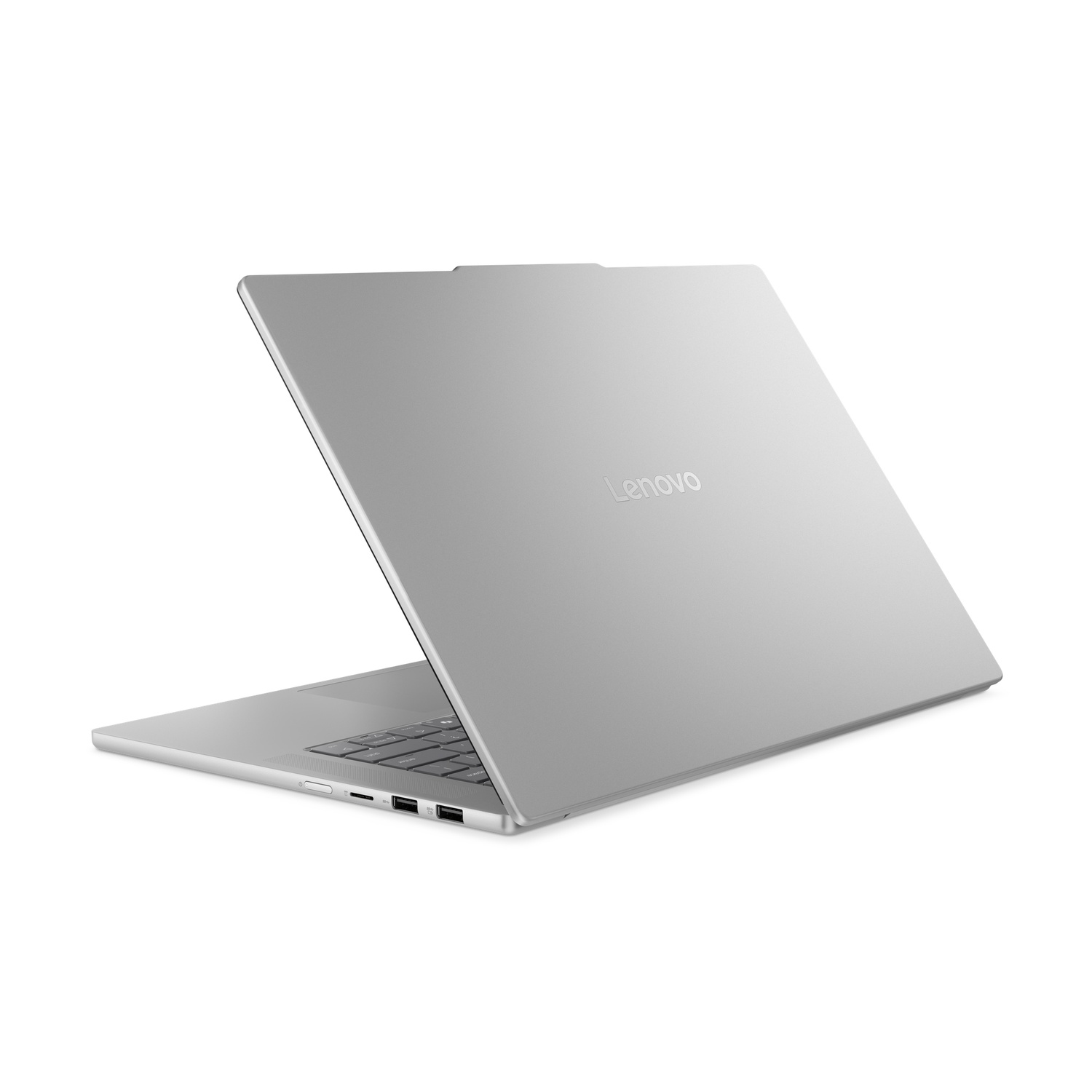 Ordinateur portable Lenovo argenté sur fond blanc. L'écran est ouvert, montrant le clavier et les ports. Le logo Lenovo est visible.