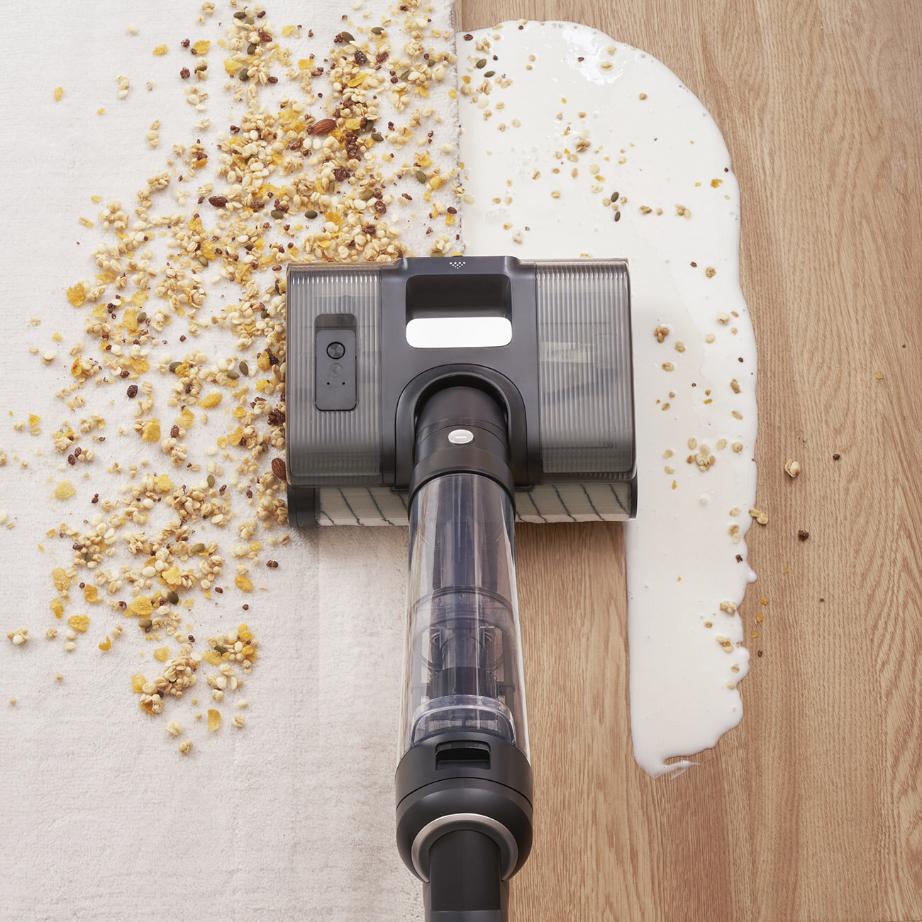 Odkurzacz czyści płatki śniadaniowe i rozlanie mleko. Po lewej płatki na białym dywanie. Po prawej mleko na drewnianej podłodze.
