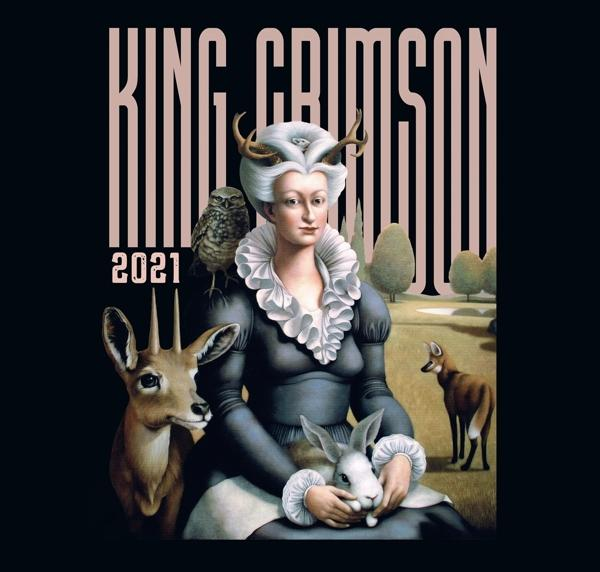 Egy szarvas nő bagollyal, szarvassal és nyúllal ül. A háttérben egy róka áll. A tetején a 'KING CRIMSON' felirat látható.