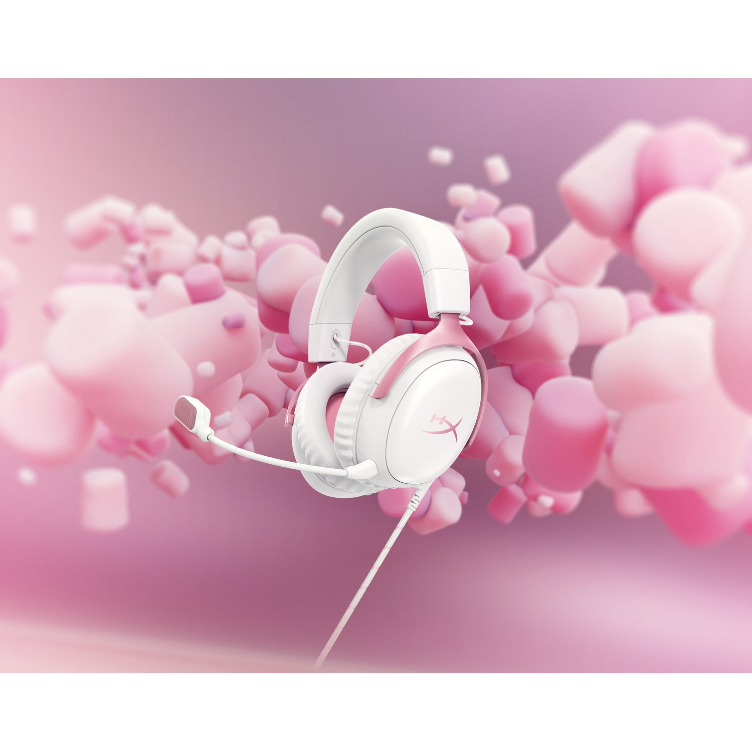 White and pink gaming headset with a microphone. Background features blurred pink marshmallow-like shapes on a pink gradient.